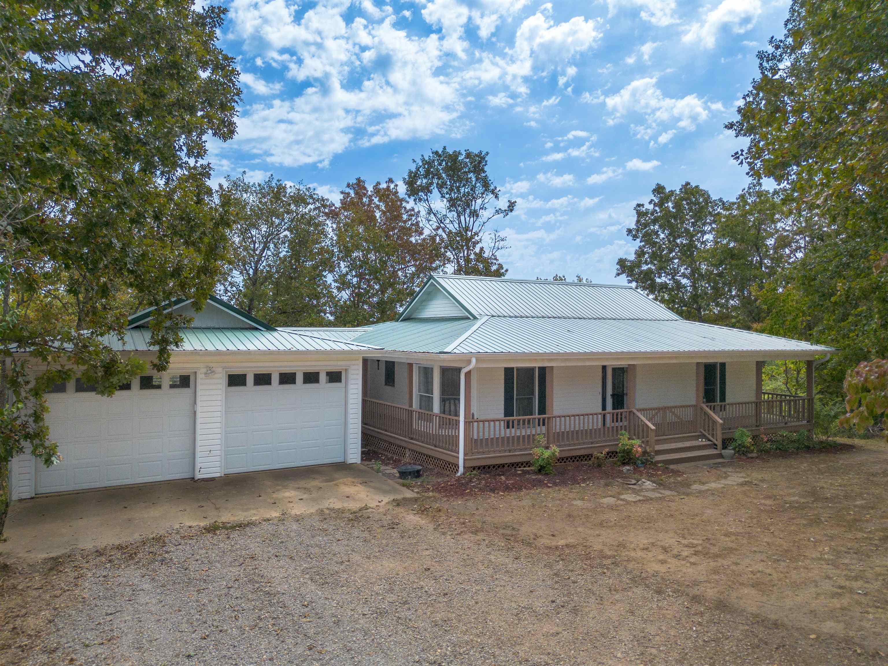 RIVERFRONT OZARKS RETREAT ON 17 ACRES! Escape to your private sanctuary on the banks of the Southfork River. This spacious country home at 1100 River Hill Rd in Glencoe offers 2,746 sq ft of living space, with a main level master suite and a fully finished walk-out basement. The home features 3 bedrooms, 2.5 baths, a large living room with fireplace, and a formal dining room. Key updates include a newer HVAC, metal roof, and home generator all in 2023. The exterior boasts a large deck overlooking the river, a wrap-around porch, and numerous outbuildings: a 2-car insulated garage, TWO new metal shops with concrete floors, and a large RV/equipment shed. The 17 mostly wooded acres provide ultimate privacy, a large garden area, fruit trees, and direct river access for fishing, kayaking, and swimming. A true Ozark gem!