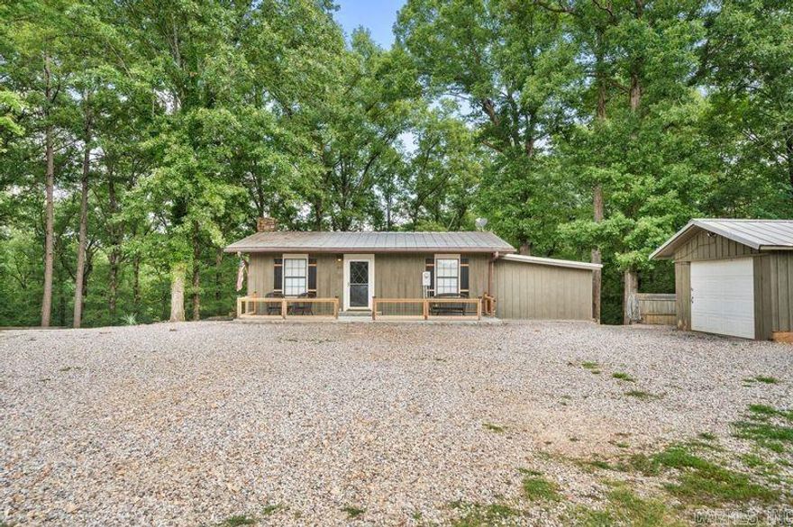 ***BACK ON MARKET*** Back on market due to no fault of seller. This charming 3-bedroom, 2.5-bathroom home is nestled in the highly sought-after Magnet Cove School District, offering a perfect blend of comfort and convenience. Recently upgraded with a new heat pump and air conditioner in 2023, along with new insulation upstairs, it ensures modern comfort and efficiency year-round. Inside, the home boasts luxury vinyl plank and tile flooring throughout, making maintenance a breeze. A cozy wood burning fireplace adds warmth and ambiance, perfect for chilly evenings. The metal roof provides durability and longevity. While outside, you'll enjoy a serene 1.73-acre property with private views of the woods, multiple decks for entertaining and a small creek, adding to the tranquil atmosphere. For additional storage and convenience, there is a one-car garage. This property offers a peaceful retreat with the benefits of modern updates, ideal for those seeking a comfortable home in a picturesque setting.