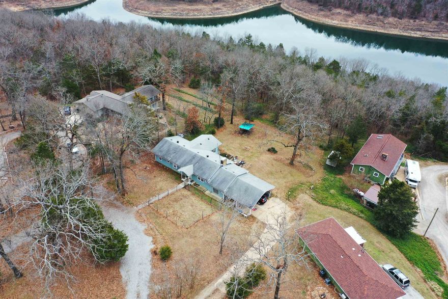 Beautiful lakeview 4 Bedroom 2 Bath home on Bull Shoals Lake with property backing up to Corps Line.  Updated kitchen, large dining area with a living room that adjoins the family room with a cozy fireplace.  Lower level has bedroom, fireplace and laundry. Plumbing has PEX and ABS were installed in 2022. 2 car oversized covered carport and lower-level utility garage with workshop area. Seller will give $10,000 credit on sales price for chimney repairs.