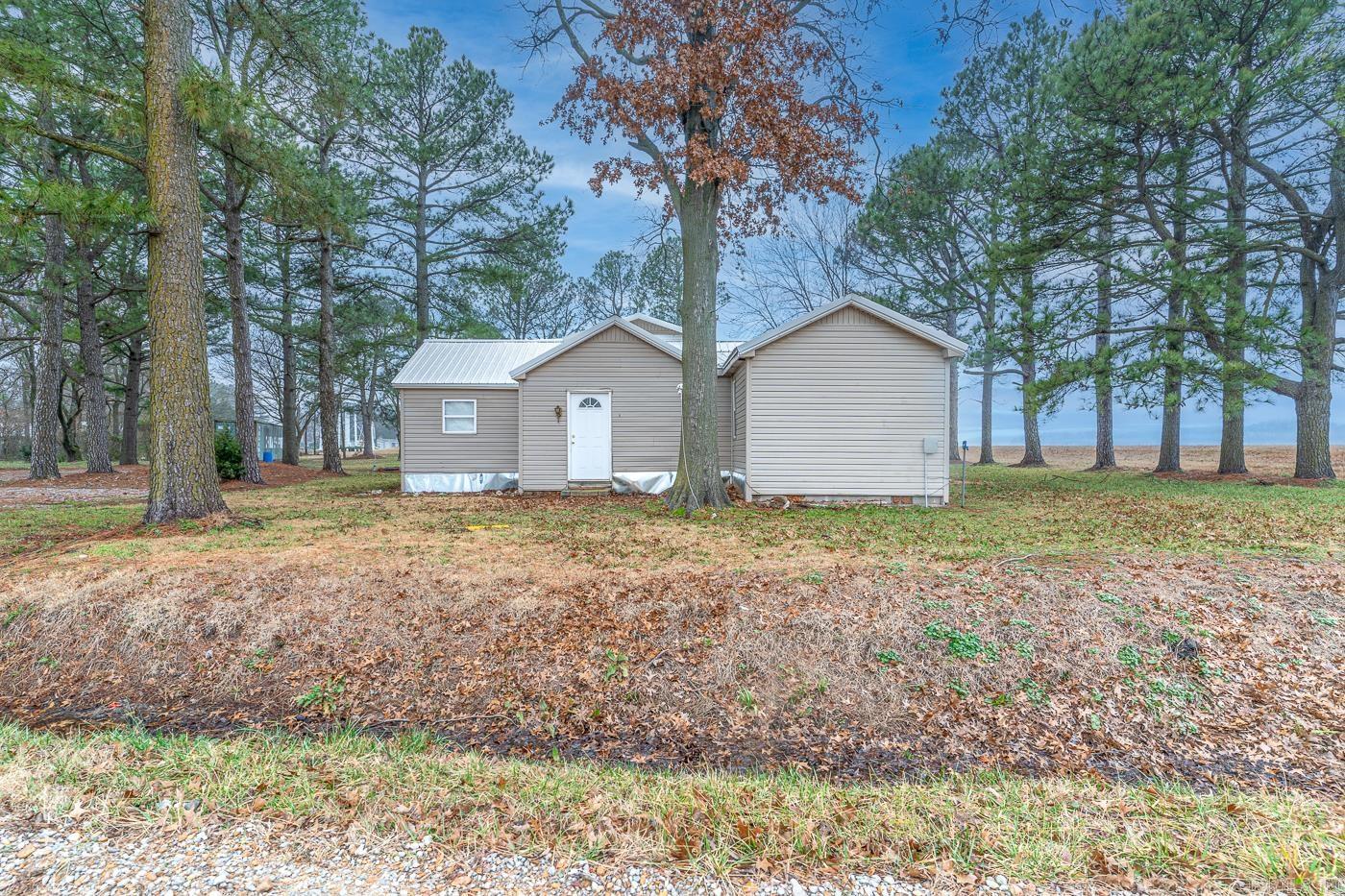 Welcome to Market 8141 Riviana Lane of Weiner, Arkansas in Poinsett County. Known as "The Pine Grove," this turnkey, fully furnished and move-in ready duck hunting lodge is ready for your next adventure. Situated on one +/- level acre sprinkled with pine trees is a 1954 built house wrapped in vinyl, topped w/ a 2024 metal roof, and accented by an accessible covered wooden deck. The interior features 1,678 sf of well laid out living space that contains an eat-in kitchen with stainless steel refrigerator, electric range, dishwasher, and microwave, 4 bedrooms, 1 bathroom w/ shower/tub combo, 1 half bathroom, living room, and utility/laundry room with washer and dryer. Recent improvements include: roof, flooring, fresh paint, appliances, and gravel driveway with additional parking. You'll love the scenic views, bonfire pit, 40 ft Conex storage unit, storm shelter, gun safe, freezer, and that this lodge comes fully furnished and has accomodations for 12. Weiner and nearby areas are world renowned for their hunting and fishing opportunities. Call today to schedule your tour and make an investment in tomorrow.