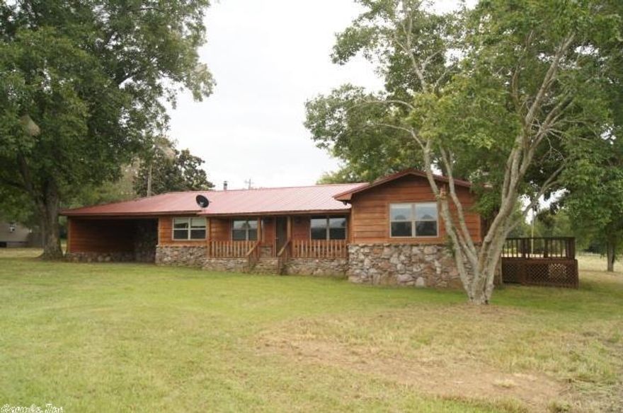 This is a 3 bedroom, 2 bath rock and cypress home.  Will need appliances and a look at the heating system but all of this is reflected in the price.  There is a large red barn in the back yard and has 2.11 acres.  See agents remarks.
