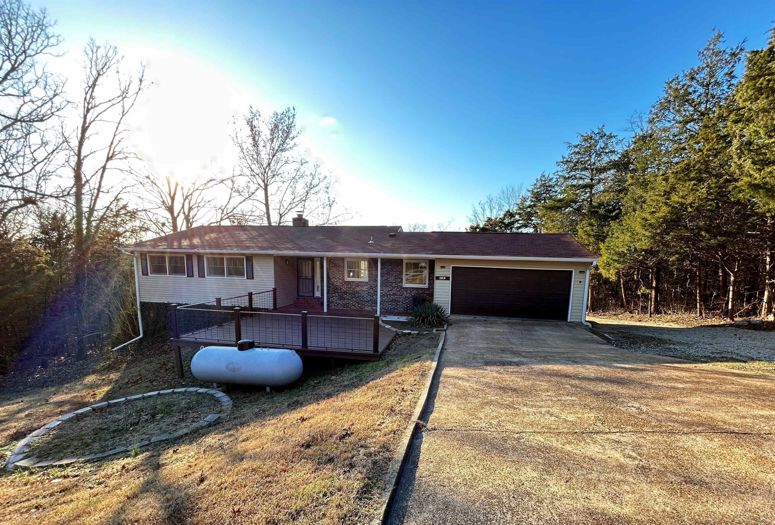 Don’t miss this newly remodeled, spacious home! Updates include fresh interior paint, refinished wood floors, a fully remodeled kitchen with new cabinets, countertops, and a farmhouse sink, plus updated bathrooms with new vanities. The entire home is illuminated by all-new LED lighting. Enjoy the convenience of an oversized garage with an automatic opener, a brand-new front deck, and updated guttering and roof only a few years old.   This home offers plenty of space with two living areas—3 bedrooms and 1 bath on the upper level, and 3 bedrooms and 1 bath on the lower level. There is dual heating system + gas radiant wall heaters on both levels for extra warmth, complemented by a wood-burning fireplace in the basement. The lower level also features a private entrance, making it perfect for guests or extended family.  Nestled on a quiet street surrounded by woods, this home provides privacy and tranquility. Enjoy stunning views from the large picture windows at the back and take advantage of its proximity to Turkey Mountain Golf Course and Crown Lake. Call today to see this incredible home!