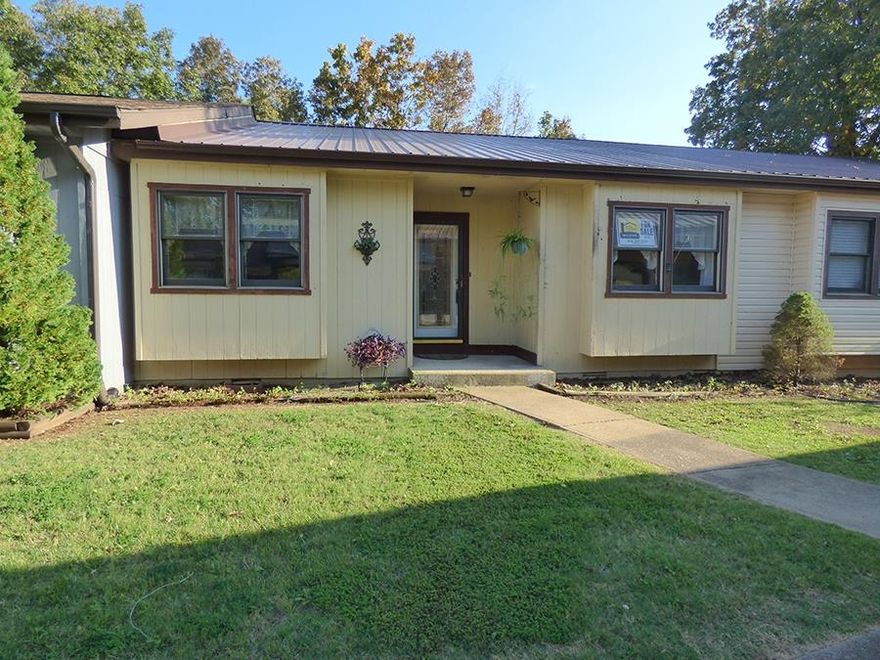 AVAILABLE FOR IMMEDIATE MOVE-IN!   Comfortable living on a quiet, low-traffic street conveniently located just above the Town Center's post office, art center, beautiful Papoose Park, and occasional Village festivals and music. 1446 sq ft of living space that offers 2 bedrooms, one large enough for king-sized furniture, 2 baths, walk-in shower, lots of closet space including a walk-in cedar closet, kitchen with stove, refrigerator, microwave, dishwasher, disposal, and almost new washer and dryer, large open living room/dining area with built-in buffet and shelving, the sun room perfect for plants and office or hobby space, central heat & air, and ceiling fans in every room.  Underneath is the unfinished storage/tool area with water softener, work bench, shelving and concrete floor.  The town house interior is drywall, exterior is wood siding with double pane windows, two-car  carport, and  metal roof.  Walk half a block to the town house indoor heated pool or outdoor pool, and reserve the community room with kitchenette for parties or neighborhood meetings.  Carpet throughout warm to the feet and legs and new vinyl in the kitchen.