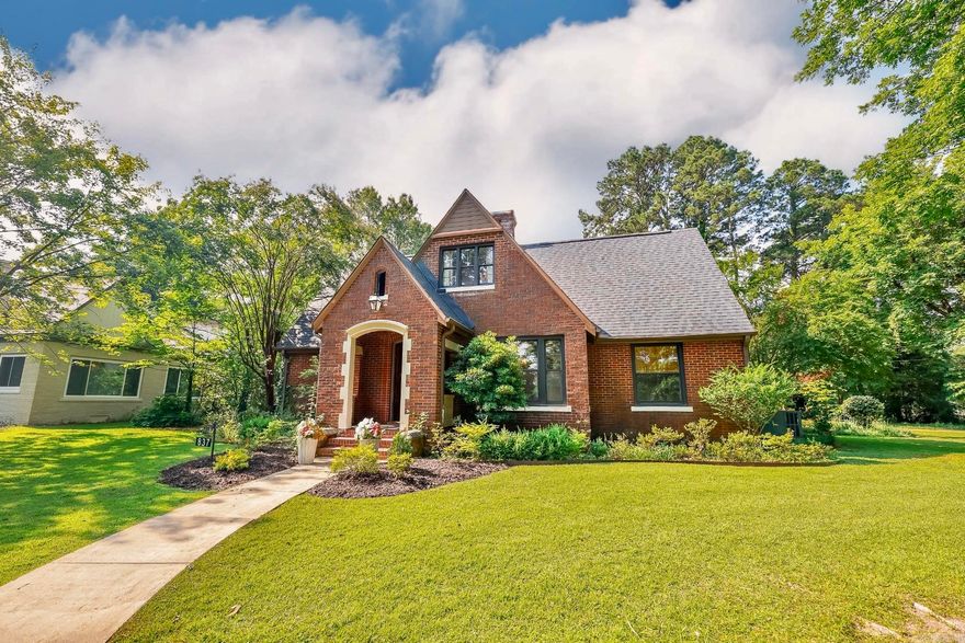 Listed on the National Register of Historic Places, the Laney House is a beautifully renovated English Tudor offering 4 bedrooms, 2.5 baths, and timeless charm with modern upgrades. Features include new electrical, plumbing, roof, custom kitchen with marble counters, built-in banquette, and refinished historic hardwood floors on both levels. The main floor includes a spacious primary suite and a study with floor-to-ceiling built-ins. Upstairs has three additional bedrooms, full bath, and ample storage. The detached 2-car garage includes a generous upstairs storage area. Outdoors, relax by the fire pit, let kids explore the large playhouse, or stroll through the beautifully landscaped yard with camellias, hydrangeas, azaleas, roses, pear and plum trees, and a fenced garden. A rare find in the heart of Camden!  Property is agent owned.