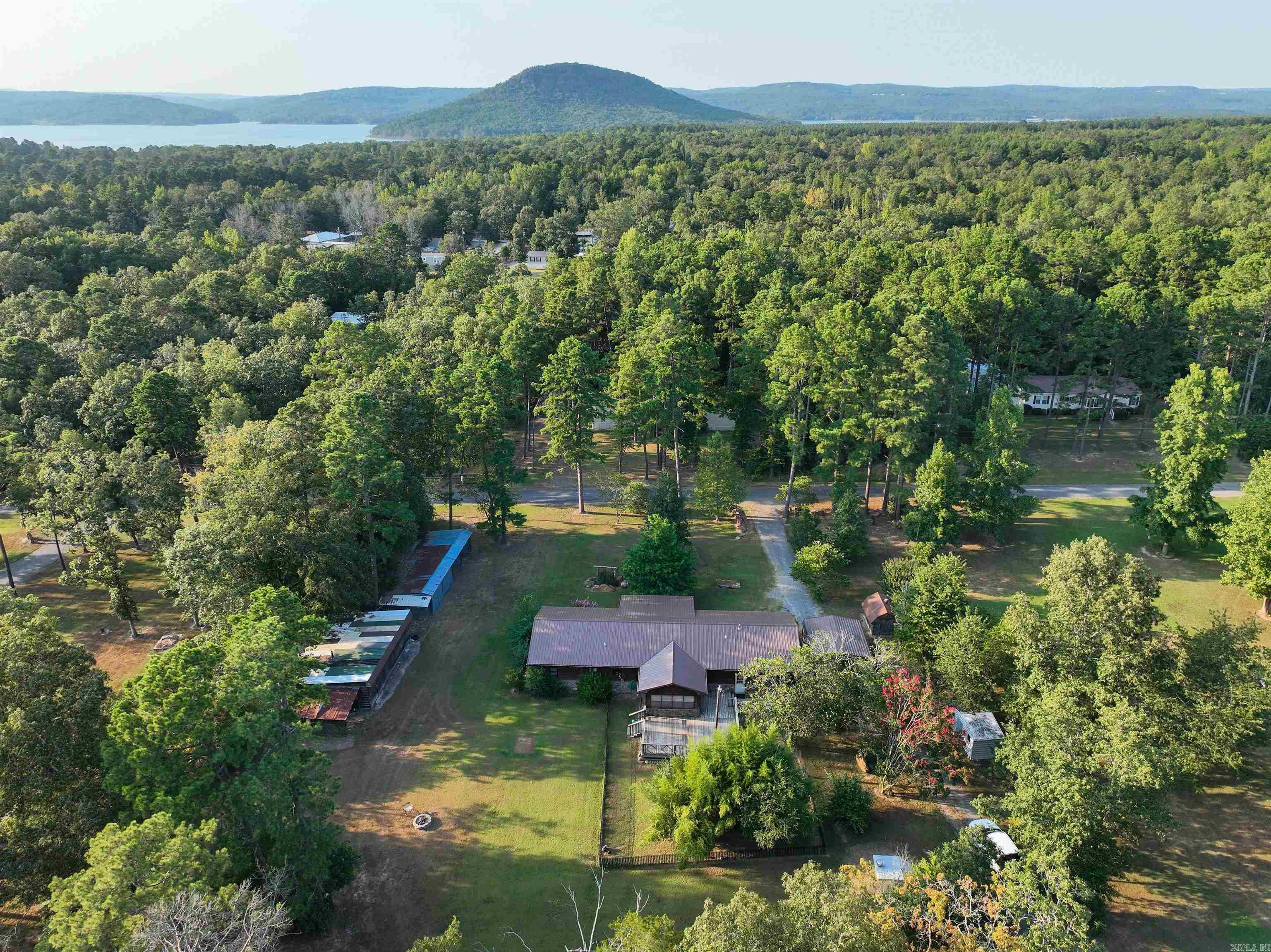 Spacious 3 bedroom and 2 bathroom cabin sitting on 1 acre awaits! Less than 10 minutes from Sugar Loaf Marina and offers plenty of storage for your boat, golf cart, and side by side. The property features lots of outdoor space with a large back deck for grilling and enjoying relaxing evenings after a day on the lake. The home has a new metal roof and added large landscape rocks throughout the yard to give it a unique feel. Schedule your showing today!