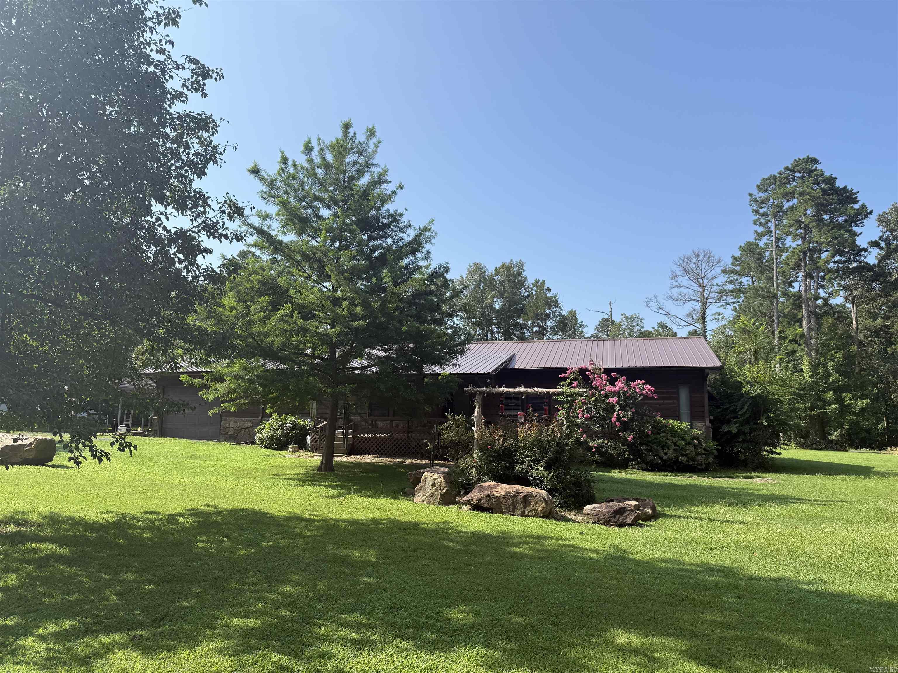Spacious 3 bedroom and 2 bathroom cabin sitting on 1 acre awaits! Less than 10 minutes from Sugar Loaf Marina and offers plenty of storage for your boat, golf cart, and side by side. The property features lots of outdoor space with a large back deck for grilling and enjoying relaxing evenings after a day on the lake. The home has a new metal roof and added large landscape rocks throughout the yard to give it a unique feel. Schedule your showing today!