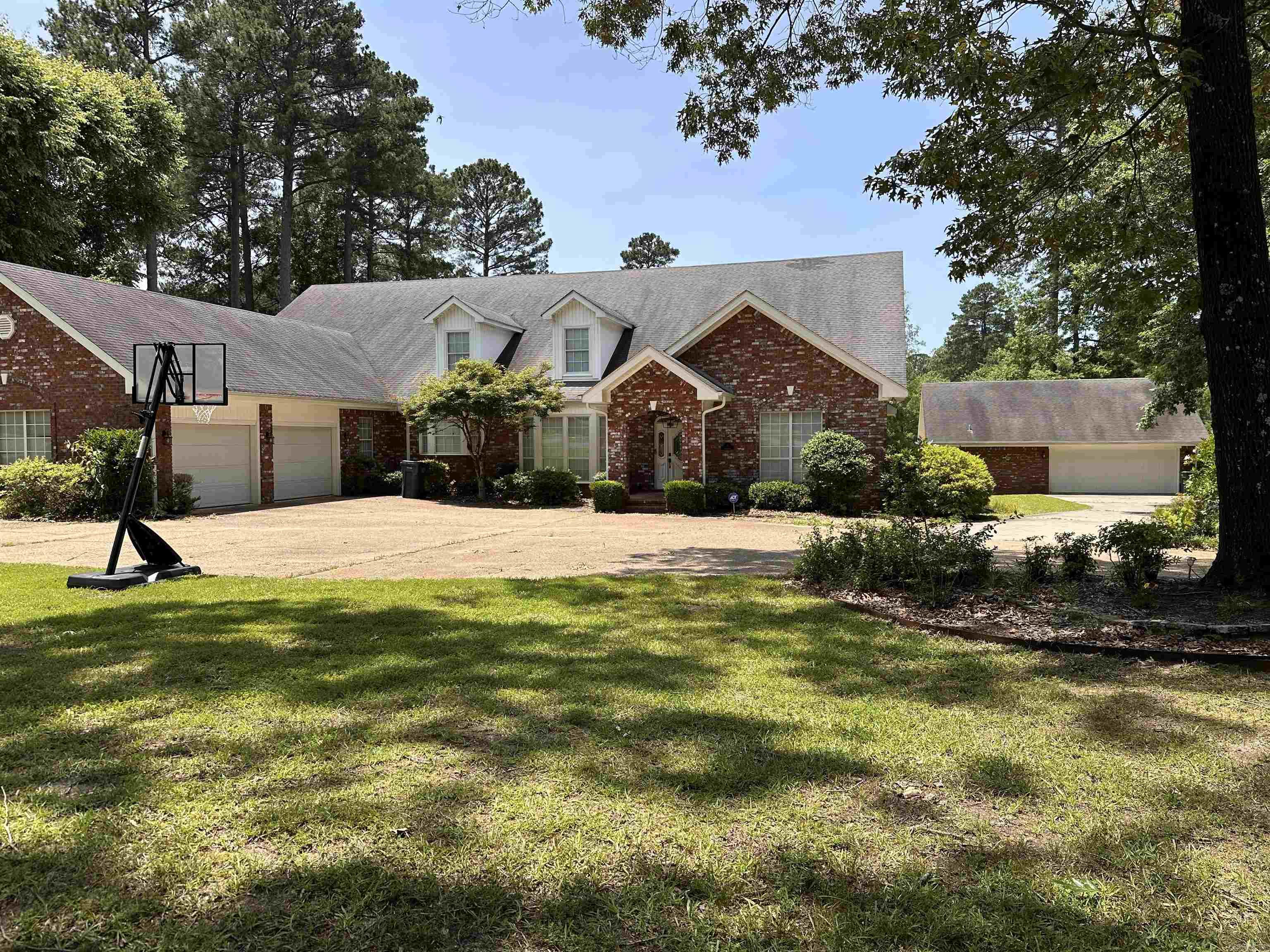 This home offers everything! When you pull into the circular drive, you will love the beautiful yard and landscaping.Upon entering the home, you will be greeted with an open floor plan showing a Family room and Dining room with great views of the pond in the back.The large kitchen has stainless steel appliances, granite counter tops, custom cabinetry and another dining area.There is plenty of light throughout the home. The primary bedroom has an in suite bathroom, sitting/study area, walk-in closet with plenty of built-ins. The bath has a jacuzzi tub and walk in shower, granite counters and separate vanities.The second & third bedrooms downstairs have an office area, in suite bath with shower. Upstairs has another entertainment area with a great view & two more large bedrooms that share a bath.There is an extra garage & workshop to the side of the home. You will enjoy nice evenings on the patio with your favorite beverage and a splendid view!