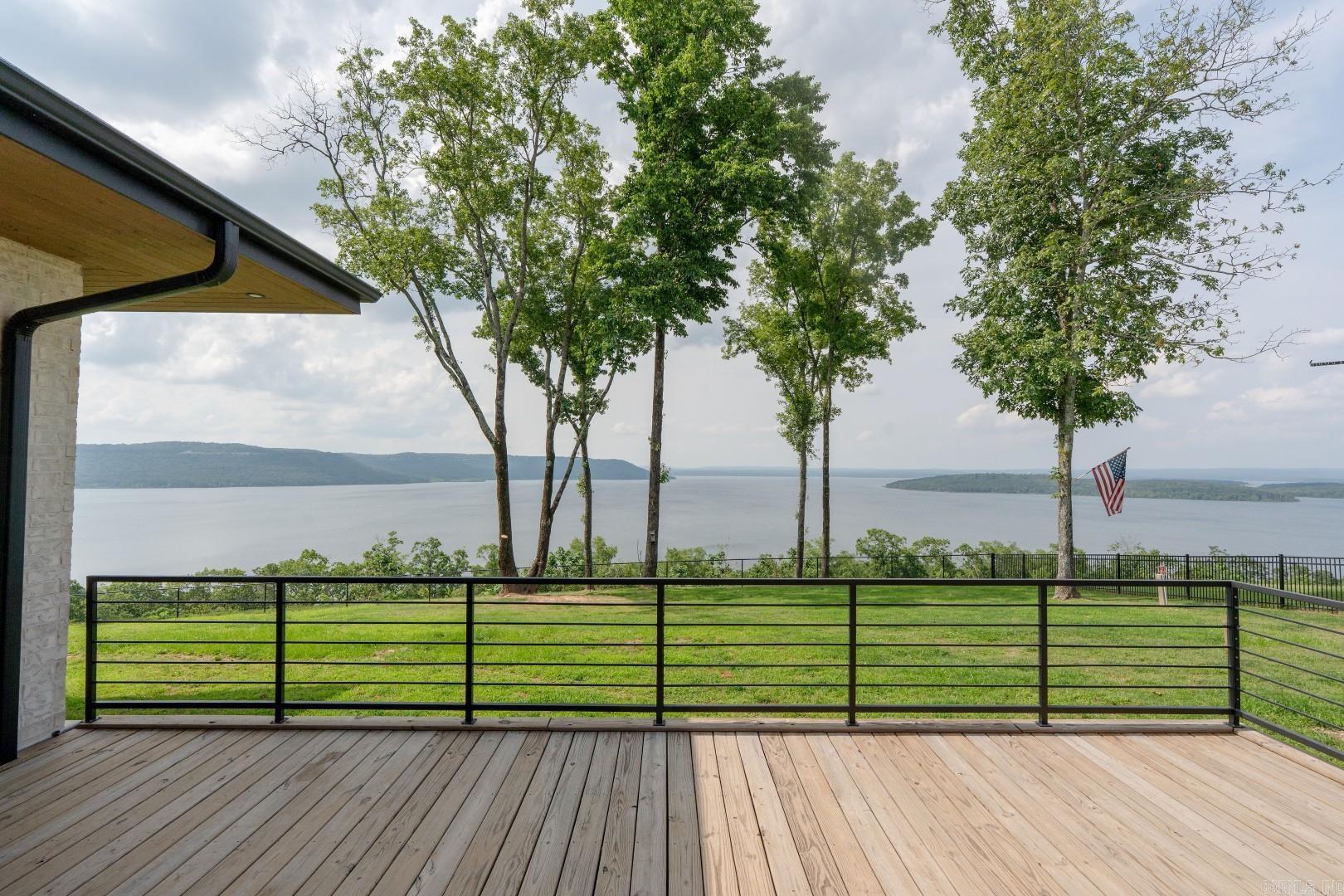 This could be the nicest piece of vacant land that I've seen in my almost 30-year real estate career! 16.49 acres with multiple lakeview building sites (that will never have to worry about trees blocking the view!), a lakefront section and drive to get from the top section down to the lake! The is a multimillion dollar home next door on 15 acres. Some of these photos (that are obviously taken from the house next door) are added to show how amazing the views are. All other photos are taken from or above the subject property. Home next door is currently on the market. Gated property, city utilities and just minutes from Eden Isle Marina and Heber Springs Marina. You probably won't have a chance to buy anything like this in Heber Springs again!