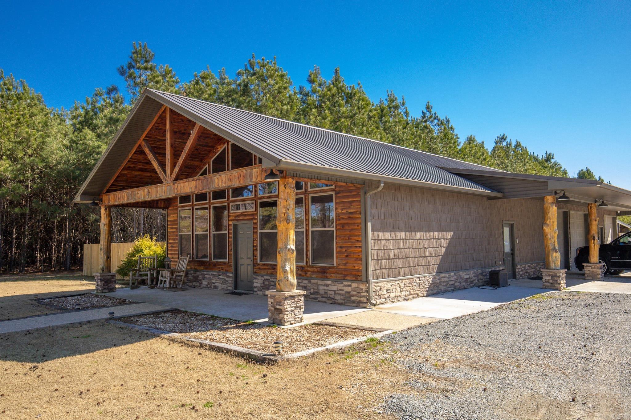 Stunning hunter's dream retreat! Custom details throughout this home include : cedar accents, granite countertops, rock fireplace & antler chandelier. Commercial fridge & stove! There is an attached garage and shop included! Outside there is also a covered area for more storage space for boats etc. Office space could be 3rd bedrooom. Everything you need right here on 3.88 acres with a very convenient location off of hwy 270 and close access to the interstate.