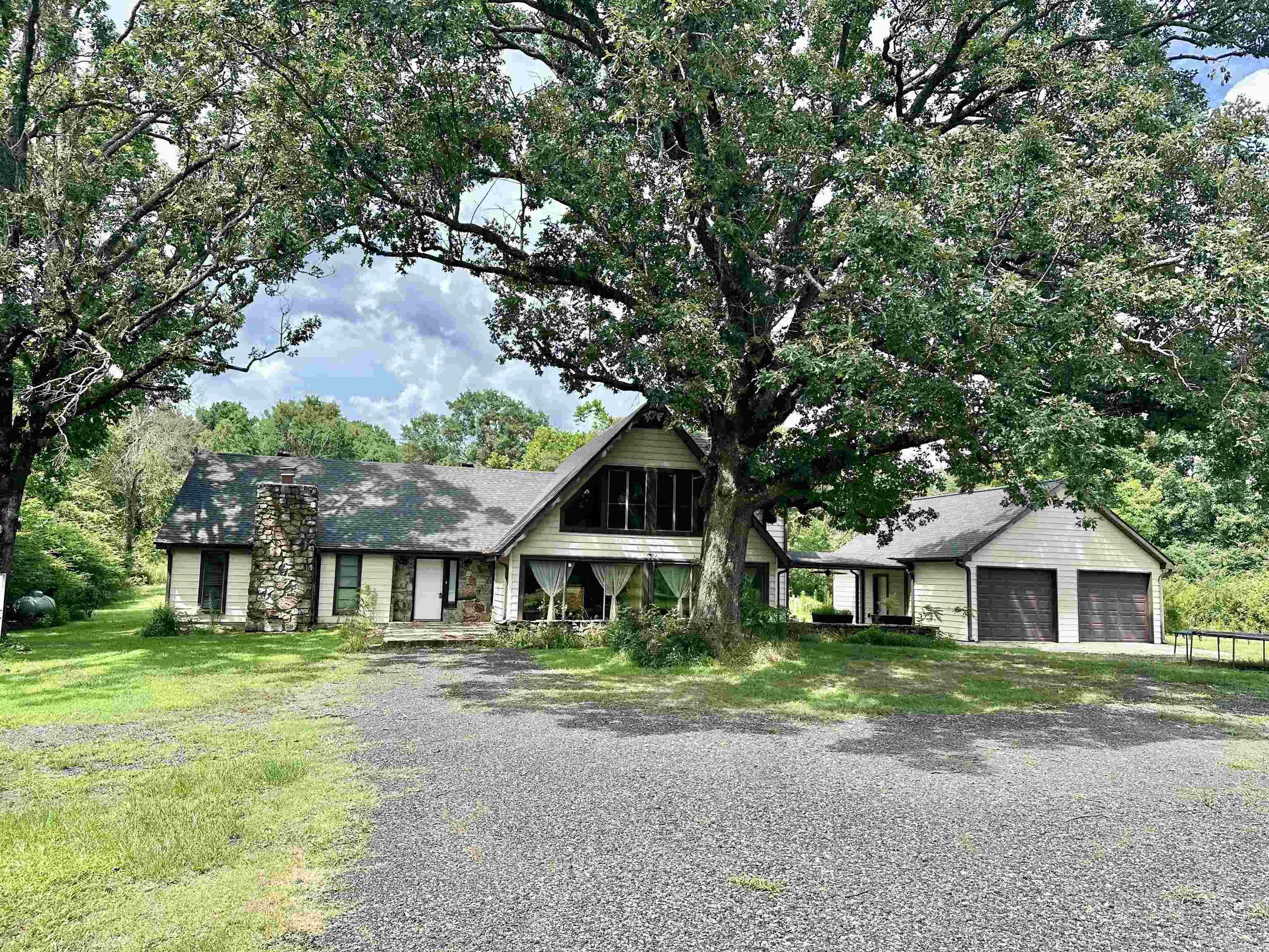 Oh My Goodness!! What a great home!! This 4 bedroom 3 full bath is amazing! It has 2 bedrooms downstairs and 2 upstairs, plenty of room for everyone! This house underwent a major remodel several years ago and they built the large garage and breezeway, new Geothermal heat/cool, at that time a Generac generator was installed to run home if electricity goes out, natural stone flooring downstairs, CUSTOM cabinetry, granite countertops and new paint and Sheetrock and more! There has been a new septic recently put too! The home has large beams in the vaulted kitchen/dining/den area with wood ceiling! Beautiful! The home sets way back off the road and has 9 acres. There is a small pond up front that needs some landscaping. The attached garage has a floored upstairs room for ALL your storage needs. Another shop/garage is on the property too, itās perfect for the zero turn and yard and garden tools and still room for a work shop! This home is only a couple miles from the largest lake in Mena- Wilhelmina Lake! Also, youāre in the Ouachita mountains and itās a short trip to the National Forest and all its beauty! This home really checks A lot of boxes and then some!