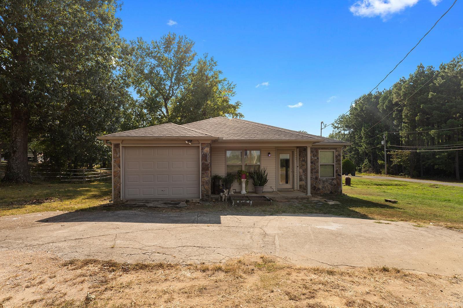 Don't miss out on this opportunity! Always wanted a shop? Check out this 30x30 shop with 2 roll doors and concrete floor, plus a cozy 3 bedroom home, with 2 full bathrooms. Separate laundry area. Enjoy relaxing evenings on your deck. Country living but close to area amenities. Call and schedule your private showing today.