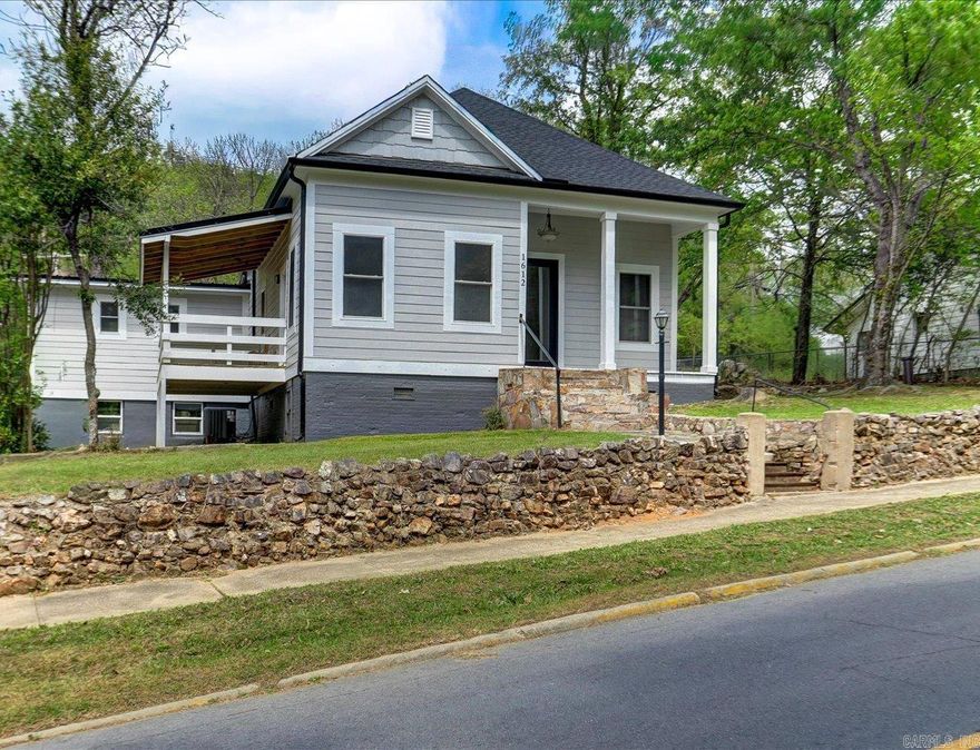 Back on Market at NO FAULT OF THE SELLER, this beautiful and thoughtfully remodeled home sits on a hill bordering the National Forest, just minutes to downtown Hot Springs. Rich in local lore, this property could have housed original gangsters or stars destined for Hollywood such as Mae West, adding unique character and charm.  The home features a spacious master suite, a well designed inviting floor plan, and strong curb appeal. Major systems have been updated including new plumbing, new gas lines, new HVAC, new ductwork, new water heater, windows, roof, grilling deck, paint, appliances, quartz- all new-offering the best of historic charm with modern reliability. Located just around the corner from well known Fawn St, this home is an exceptional opportunity. Charm, character, and complete peace of mind.