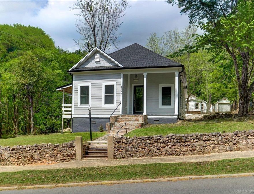 Back on Market at NO FAULT OF THE SELLER, this beautiful and thoughtfully remodeled home sits on a hill bordering the National Forest, just minutes to downtown Hot Springs. Rich in local lore, this property could have housed original gangsters or stars destined for Hollywood such as Mae West, adding unique character and charm.  The home features a spacious master suite, a well designed inviting floor plan, and strong curb appeal. Major systems have been updated including new plumbing, new gas lines, new HVAC, new ductwork, new water heater, windows, roof, grilling deck, paint, appliances, quartz- all new-offering the best of historic charm with modern reliability. Located just around the corner from well known Fawn St, this home is an exceptional opportunity. Charm, character, and complete peace of mind.