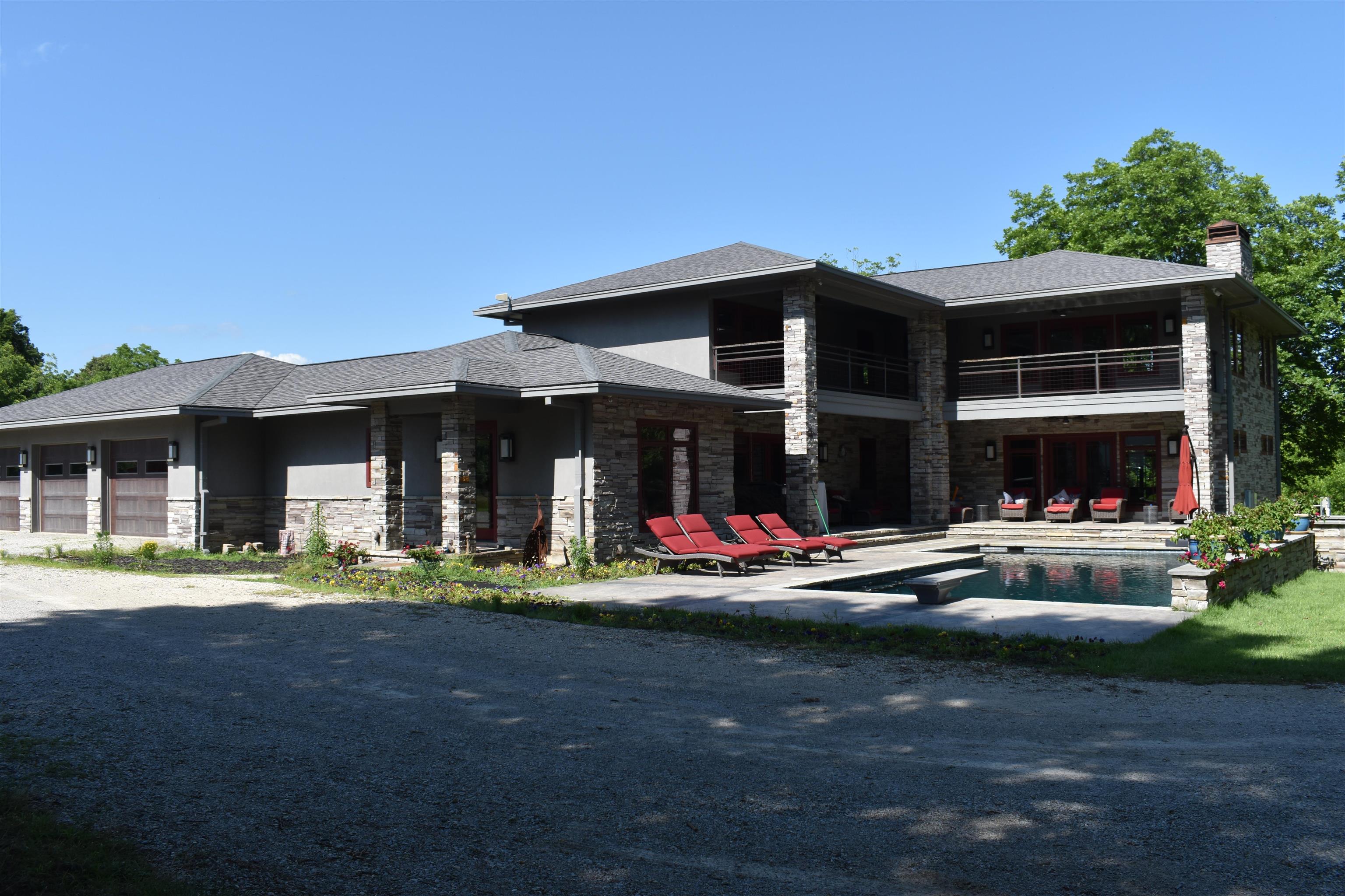 This custom-built home has so many amenities; a kitchen that would delight any chef, from the Wolf 6 burner stove to the Wolf warming drawer, to the crushed ice maker and wine cooler, cabinets and pullouts, double refrigerators, large bar that could seat a whole family plus the eat in area. If this isnāt enough, there is a very large walk-in pantry adjacent to the kitchen w full size freezer, and abundance of shelving. The dining room is more like a banquet hall w room to accommodate a large family gathering. The living room hosts a large gas log fireplace, double French doors opening onto the patio that surrounds the pool and hot tub. The master bedroom is on the main floor w/master bath hosting a walk-in shower, soaking tub, two vanities. The washer and dryer have been strategically located in the master bath. The unique staircase leads to the second level, where the large second and third bedrooms are located. The oversized three car garage is heated and cooled. GUEST HOUSE: 3 bedrooms, bath with a walk-in shower, fully equipped kitchen. There is electric water heater and propane heat. There is a storm shelter attached to Guest House.