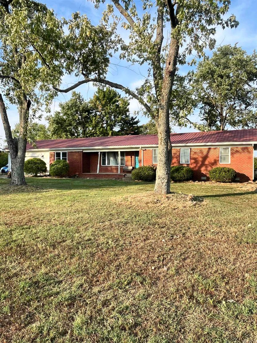 This 3 bed, 2 bath brick home sits on 2.5 acres and is packed with potential! Inside you’ll find a spacious layout, two convenient entrances, and a fenced backyard ready for pets or play.  Outdoor living is a breeze with a cozy fire pit and a backyard pergola—perfect for relaxing or entertaining.  For those needing storage or workspace, the property shines with a 40x60 red iron shop featuring 14-ft sidewalls and two bay doors—ideal for equipment, hobbies, or even a home business. Plus, the highway frontage offers great visibility and easy access.  With a little TLC, this solid home could become the comfortable residence or smart investment you’ve been waiting for.  Property sells As-Is, Where-Is.
