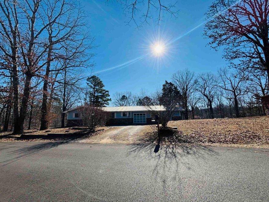This lovely 3 bedroom 2 1/2 bath home sits on 2 large lots in the beautiful Ridgeview Acres Subdivision conveniently located just minutes from downtown Mountain View and White River. The recently updated kitchen has solid oak cabinetry with new granite counter tops and tile backsplash. The inviting living room has a native stone fireplace with gas logs and hardwood flooring. Step out of the living room onto a private screened in porch with appealing woodland views. A nice office area with plenty of natural light and 1/2 bath is perfect for a study or those working from home. Adjacent to the one car garage is a covered breezeway leading to a large bonus room with a full bath perfect for a guest bedroom, in law quarters, game room, or for rental income. Under the primary bedroom is a walk-in room that serves as a safe room, small workshop, and provides easy access to the vapor barriered crawl space.  Newer HVAC & metal roof. The appliances, washer/dryer, and most furnishings are included with the sale. A 12X24 storage building with porch sits in the back yard and could be finished for guest or in law quarters, for use as a rental, a nice home office, or man or woman cave.
