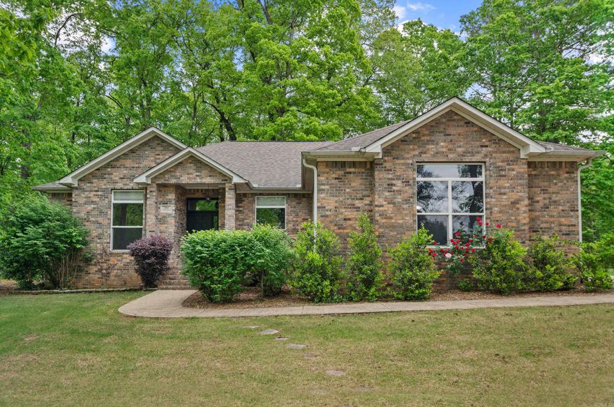 Situated on a spacious .53 acre lot in Diamondhead, this well-maintained 3 bedroom, 2 1/2 bath home offers a perfect combination of scenic surroundings, comfortable living, and practical features. From the front yard, enjoy a partial view of Lake Catherine, bringing a peaceful, scenic touch to your everyday routine. The open concept kitchen features a breakfast bar and eat-in area, seamlessly connecting to the living room, perfect for gatherings and everyday living. Separate dining area offers extra space for gatherings or formal meals. Throughout the home, beautiful tile flooring and detailed crown molding create a polished inviting atmosphere. Step outside to the screened-in porch just off the living room, a relaxing space to enjoy morning coffee, unwind in the evenings, or simply take in the fresh air year round. The fully fenced backyard is perfect for kids, pets, and outdoor entertaining, while the wired shop is perfect for hobbies, storage or projects. Lake fed sprinkler system helps keep the lawn green and healthy with minimal effort.