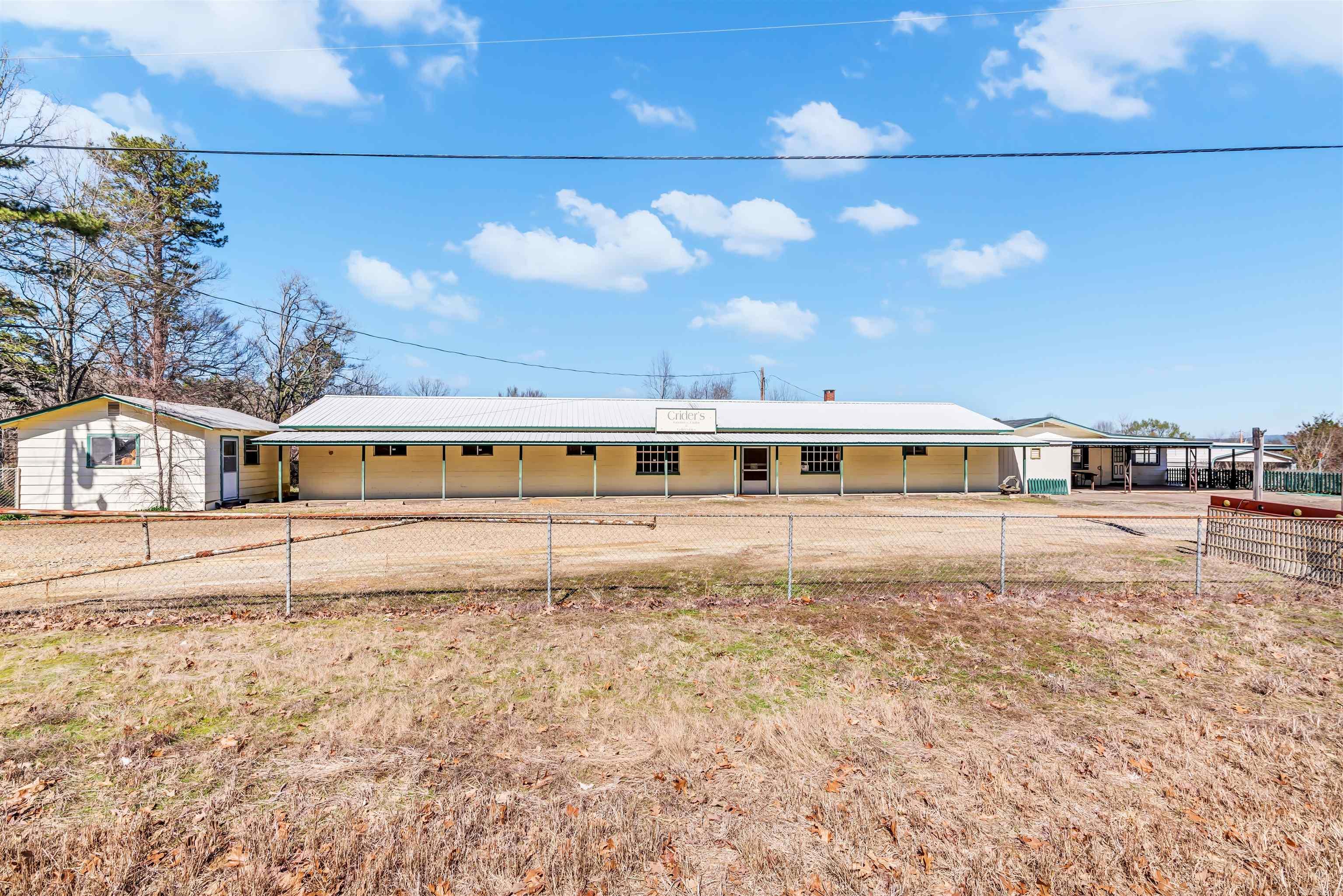 Location Location Location!! Prime Hwy Visibility! Commercial Building with a Circle Drive! The Commercial Building is currently Set Up with Antique/Flea Market Booths! Living Quarters is Open Floor Plan with a Master Suite in the Lower Level! The Lower Level of the Home Walks Out into the Backyard! 30' x 50' Shop is in the Back Yard with a Large Garage Door & It's on a Concrete Slab! Chain Link Fence in place for Your Fur Babies!! RV Carport! Convert the Commercial Building into a Bar, a Store, a Restaurant or even Climate Controlled Storage!