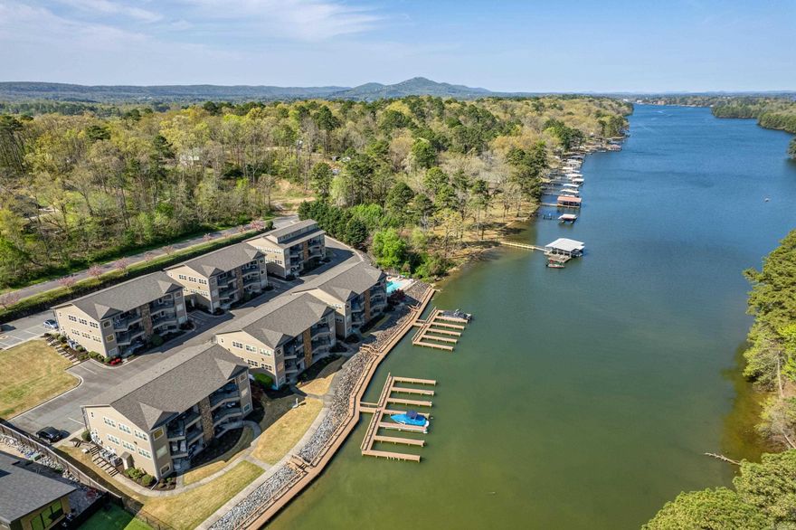 This stunning 2-bedroom, 2-bathroom condo, located on the third floor, offers the best panoramic view in the complex. With over 1,464square feet of living space, this home provides breathtaking northern-facing views of Lake Hamilton and Garvan Gardens, allowing you to enjoy the perfect combination of serene lake vistas and sunsets without the direct heat of the sun. The spacious open-concept kitchen flows seamlessly into the large living areas, creating an ideal space for both relaxation and entertaining. A cozy gas fireplace adds warmth, while the private balcony – accessible from both the master bedroom and the living room – offers the perfect spot to unwind and take in the spectacular views. Outside, you'll find a private pool right on the lake, along with a charming boardwalk that’s perfect for fishing or an evening stroll. Located in the highly sought-after Lakeside School District and just a short distance from the bypass, this condo offers both convenience and beauty. Don't miss your chance to own this exceptional property with the best panoramic view in the complex – schedule a tour today!