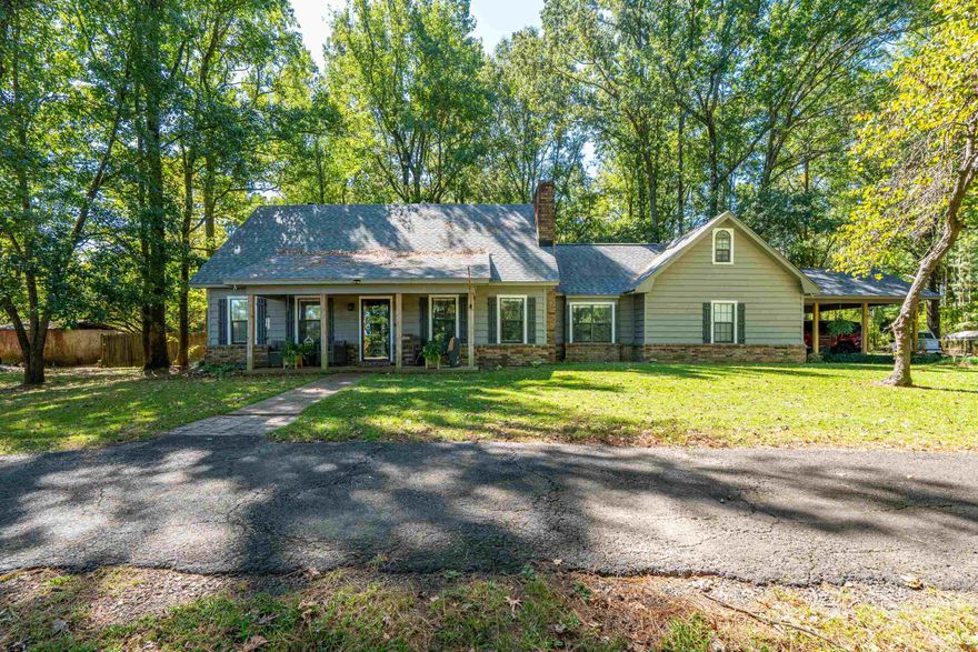 Charming Two-Story Home on 2.42+/- Acres – 7104 HWY 67, Gurdon, AR   Set back from the road beneath a canopy of mature trees, this beautiful 4-bedroom, 3.5-bath home welcomes you with warmth and character. The long, shaded drive leads to a home that combines classic style with thoughtful modern updates.  Inside, you’ll find a spacious layout with multiple living areas, perfect for both entertaining and everyday comfort. The newly renovated primary suite is a standout feature—offering a generous bedroom retreat and a luxury bath with a stunning tiled shower. Additional bedrooms provide plenty of space for guests or flexible use as an office or hobby room.  A light-filled sunroom brings the outdoors in, ideal for enjoying morning coffee or relaxing while overlooking the backyard. The covered back porch extends the living space outside, where you can unwind and take in the sweeping view of your private yard.  Outdoors, the 2.42+/- acre lot provides a shaded, park-like setting with room to roam. The fenced backyard makes it perfect for pets, gatherings, and outdoor activities, offering plenty of space to enjoy. The small shop with lean-to offers a versatile space for tools & storage.