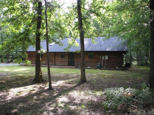 Log Cabin style home, your own "private oasis"! 2BR/2BA, open floor plan w/solid cedar walls through out. New roof, new paint, flooring & dishwasher installed 2024. Genuine claw-foot bath tub, large washroom & pantry. Huge living room w/woodburning fireplace. Skylights offer lots of natural light. Outside is a spacious covered back porch with view of pond. 10.85 AC of large hardwoods, perfect to attract abundant wildlife. Lots of deer! Property located just outside Camp Robinson's 32,000 acres of protected lands. 30' x 39' Insulated shop; well lit w/110v & 220v power. 16' Center height, 10' sidewalls, & room for attic storage. 10' x 8' Roll-up door, vented wood burning stove, & built-in work stations. 2 Large covered areas for mowers & equipment. Lots to see! Agents see Showing & Agent Remarks. Additional 10' x 23' covered pad & 12' x 26' shed. Property "Under Surveillance".