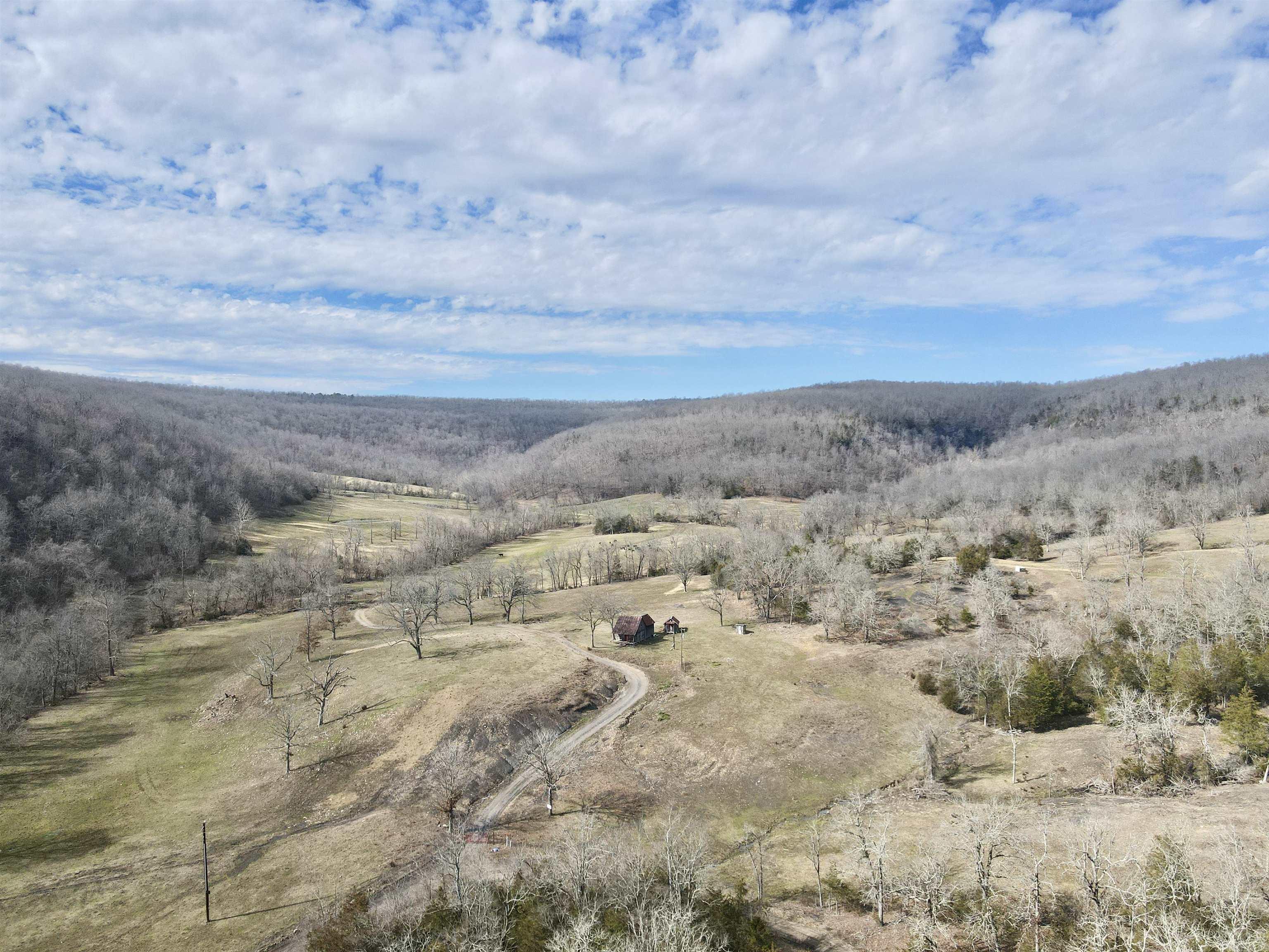 This 336.22-acre cattle farm and hunting property, located just outside of Leslie, Arkansas, offers a perfect combination of productive farmland and prime wildlife habitat. With expansive pastureland, a creek, and five ponds, itās well-suited for cattle operations while also attracting an abundance of wildlife. The mix of open fields and wooded areas provides excellent hunting opportunities for deer, turkey, and bear. ATV trails run throughout the property, making it easy to navigate and manage. A rustic homestead log cabin that was built in the 1800's sits on the land, offering a piece of history and the potential for restoration. Electric, high speed fiber internet, and a hand dug well are located on the property. Whether youāre looking for a working farm, a recreational retreat, or a hunterās paradise, this property delivers on all fronts.