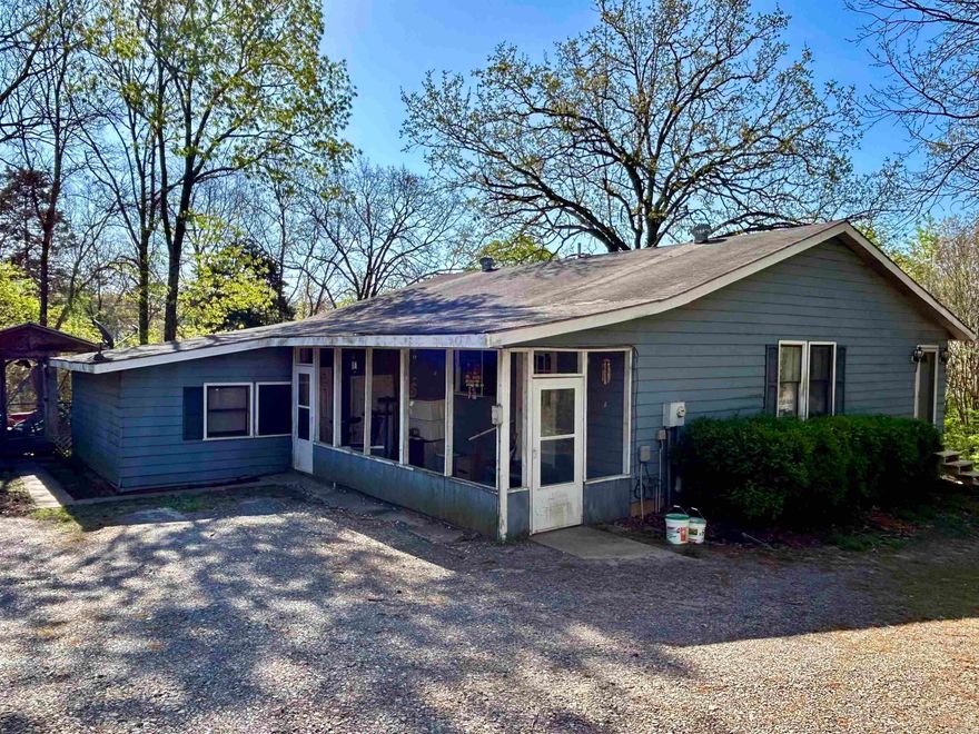 Large home about a block away from beautiful Greers Ferry Lake.  This two story home would make a great home, rental, or vacation getaway.  With almost 3,000 square feet, 4 bedrooms and a couple of spaces that could serve as additional bedrooms, 2 baths with another unfinished bathroom...there is plenty of space to spread out and everyone have their own space.  it has a spacious open design in the Kitchen/dining room/living room, and substantial cabinet space.  The AC is less than 2 years old, so your new home will stay nice and cool for the summer and warm for the winter.  The shop is ready to go for an actual....or wannabe.....or gotta be.....mechanic in your family. In the yard you will find that there is a storage building, a pole barn to park your boat, and a two entrance/exit driveway. Come take a look! Schedule your showing today.  Finding a house this close to the lake at this price is a rare find.