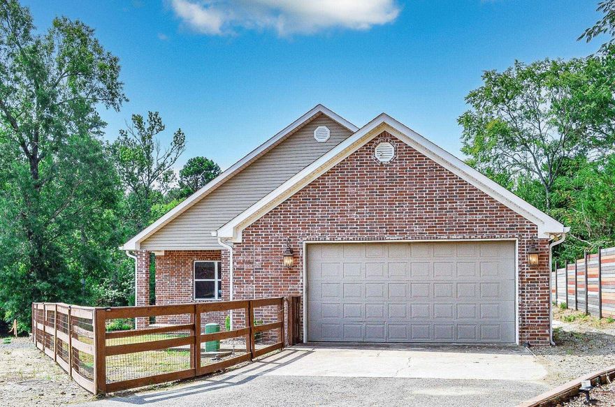 Beautiful lake front home on Lake Hamilton. This custom home has so much to offer! Beautiful hardwood vaulted ceiling in the living room and kitchen. Many interior walls are brick.  Wood floors in 3 bedrooms. Large island in the kitchen for easy entertaining. Bosch appliances. Granite counters. Split bedrooms. 3 bedrooms within the main house, one private bedroom and bath with access from the deck. Kitchen, dining, Living room and baths have tile floors. Lake front boasts a swim dock with ladder. Oversized 2 car garage. This home is currently an Airb&b. AGENTS SEE REMARKS