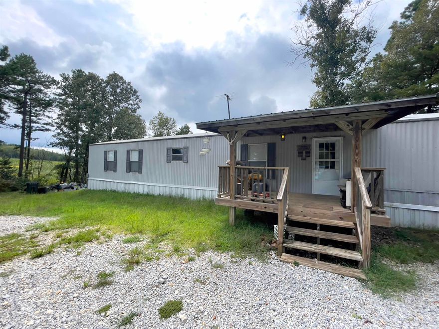 Great starter home, rental investment or weekend getaway. This 2-bedroom 2 bath mobile home has a covered front porch and back deck with 3.89 acres and just a short distance from Mountain View. Nice sized yard that could accommodate a few animals and a garden.