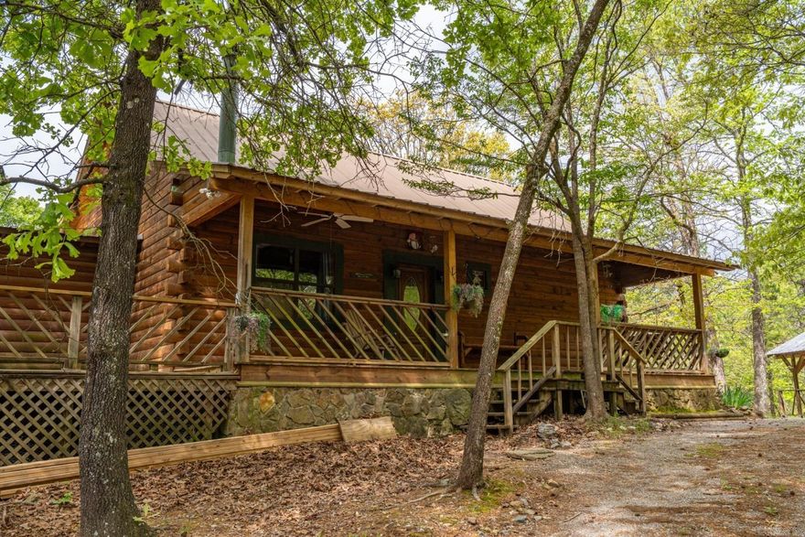 Log Cabin livin' with a killer view! Own your own little piece of paradise in the mountains. Located just 2 miles from the round about outside the Village gates. From the moment you walk thru the front door you are transported to a hunting lodge with warm wood tones, natural lighting and breathtaking views of the surrounding mountains. With 3 bedrooms and 3 full baths in the main home you'll have plenty of room for everyone in the family. The large open floor plan makes entertaining a breeze or move your party downstairs to the huge bonus room. The massive back deck overlooks the 5+ acres and has a walkway to the garage apartment with a bedroom and full bath for your overnight company. So gather your family and guests for a night of star gazing on the back deck! Welcome Home!