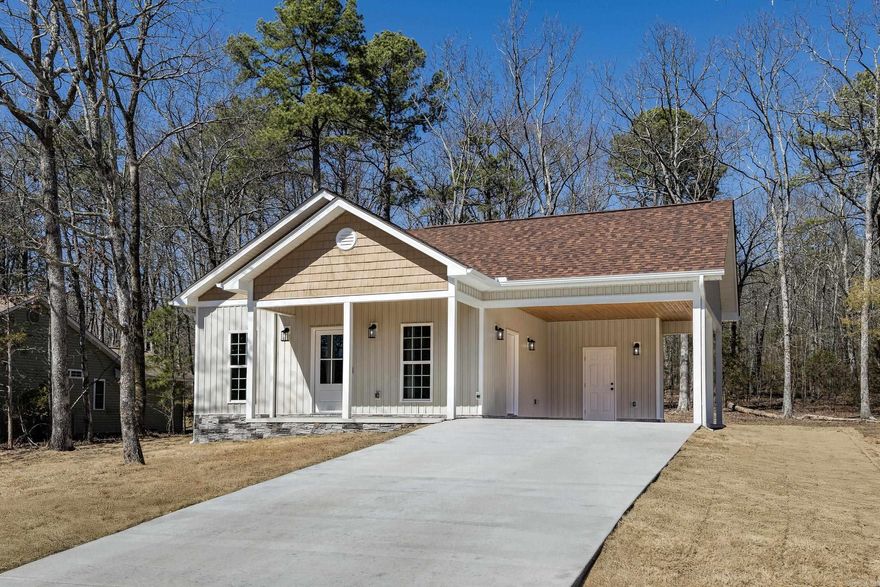 With an accepted offer seller will either pay buyer's closing cost up to but not to exceed $5000 or will pay for a 2-1 rate buy down.    Nestled in the heart of a golfing and boating haven, this property offers breathtaking views of the natural landscape teeming with wildlife from almost every room. Located in the prestigious Fairfield Bay Resort, you'll enjoy world-class amenities, including two award-winning golf courses, the pristine waters of Greers Ferry Lake, 90 miles of UTV trails, seven swimming pools, and numerous hiking adventures.  Home Features: 3 bedrooms, 2 full baths Open-concept great room with kitchen, dining, and living areas Gourmet kitchen with granite countertops, dining and bar seating Frigidaire refrigerator and range included Walk-in closets, Barnwood Lifetime Warranty Floorig, and ceiling fans for comfort Smart design with automatic night light receptacles and USB-C outlets for rapid phone charging. Concrete patio with primary bedroom access.  Exterior Highlights: Lot backs up to serene wooded greenspace Bermuda sod lawn with a smart irrigation system Double carport and large driveway for ample parking  One block from the iconic Indian Hills Golf Course