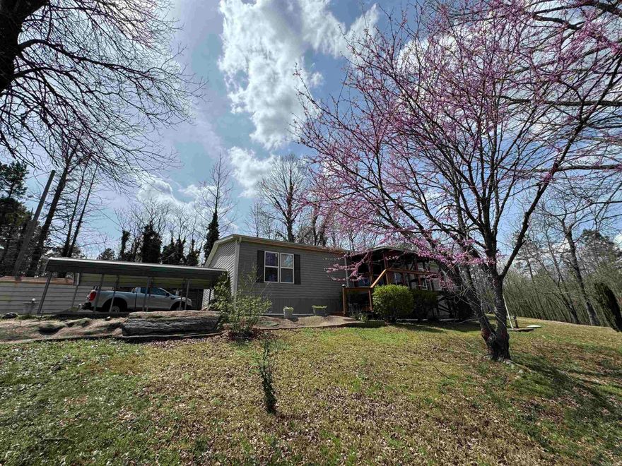 Four bedroom, two bathroom on just under 2 acres in the county. Covered porch with great views to unwind and a covered patio off the kitchen for those afternoons when you fire up the grill. Lots of storage with the additional outbuildings. Wired for a generator for inclement weather. Home is in excellent shape. Newer electric furnace and water heater. Covered parking for 3 vehicles. Don't miss this one!