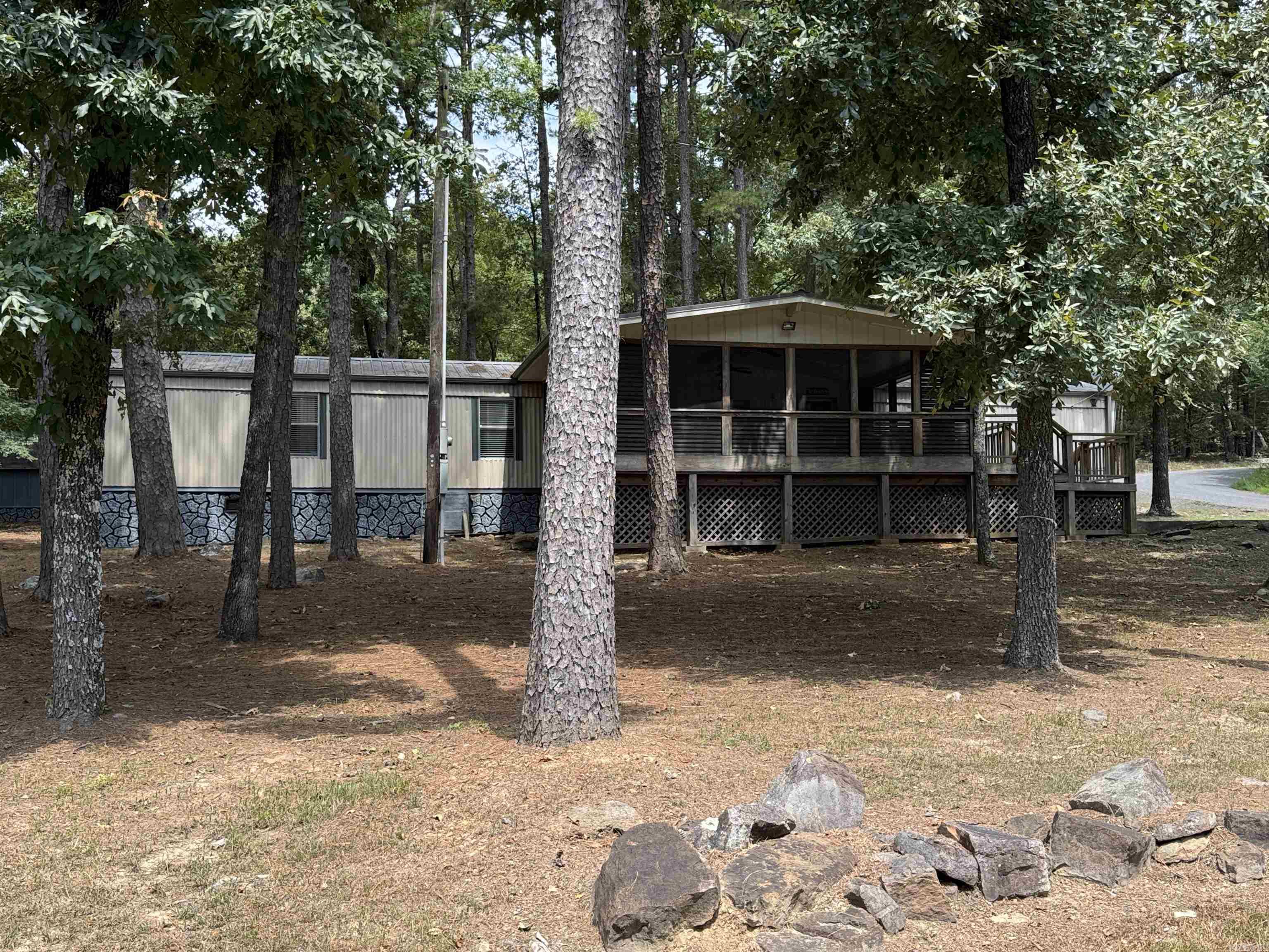 PERFECT LAKE VIEW CORNER LOT. This home is all electric with 3 bedroom 2 bath and comes with most furnishings. It sits on a .49 wooded lot with concrete driveway and a storage shed. Great area for permanent or a vacation home. Awesome covered screened front porch is super large for all your entertaining. Call Today !!