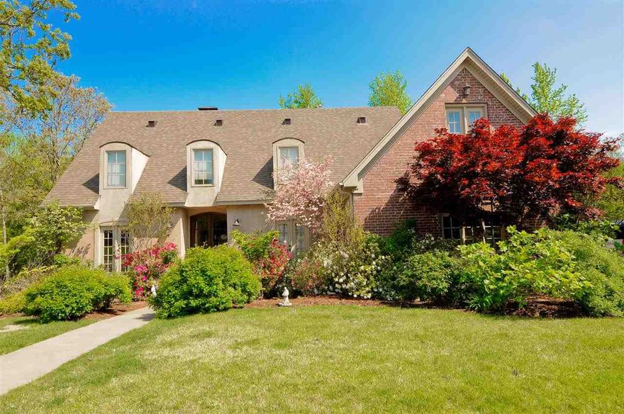 Fabulous French Country home. Open floor plan ideal for entertaining. Huge kitchen/GR with arched openings & lrge center island. granite countertops. French doors open to covered deck overlooking creek and wooded area. Formal dining room, kitchen & study have site finished hardwood floors. Master BR features sitting area with FP. Master bath has jetted tub, separate shower & travertine floors & countertops.  Basement area has media room w top of the line equipment, full kitchen, wine cellar, br & ba.