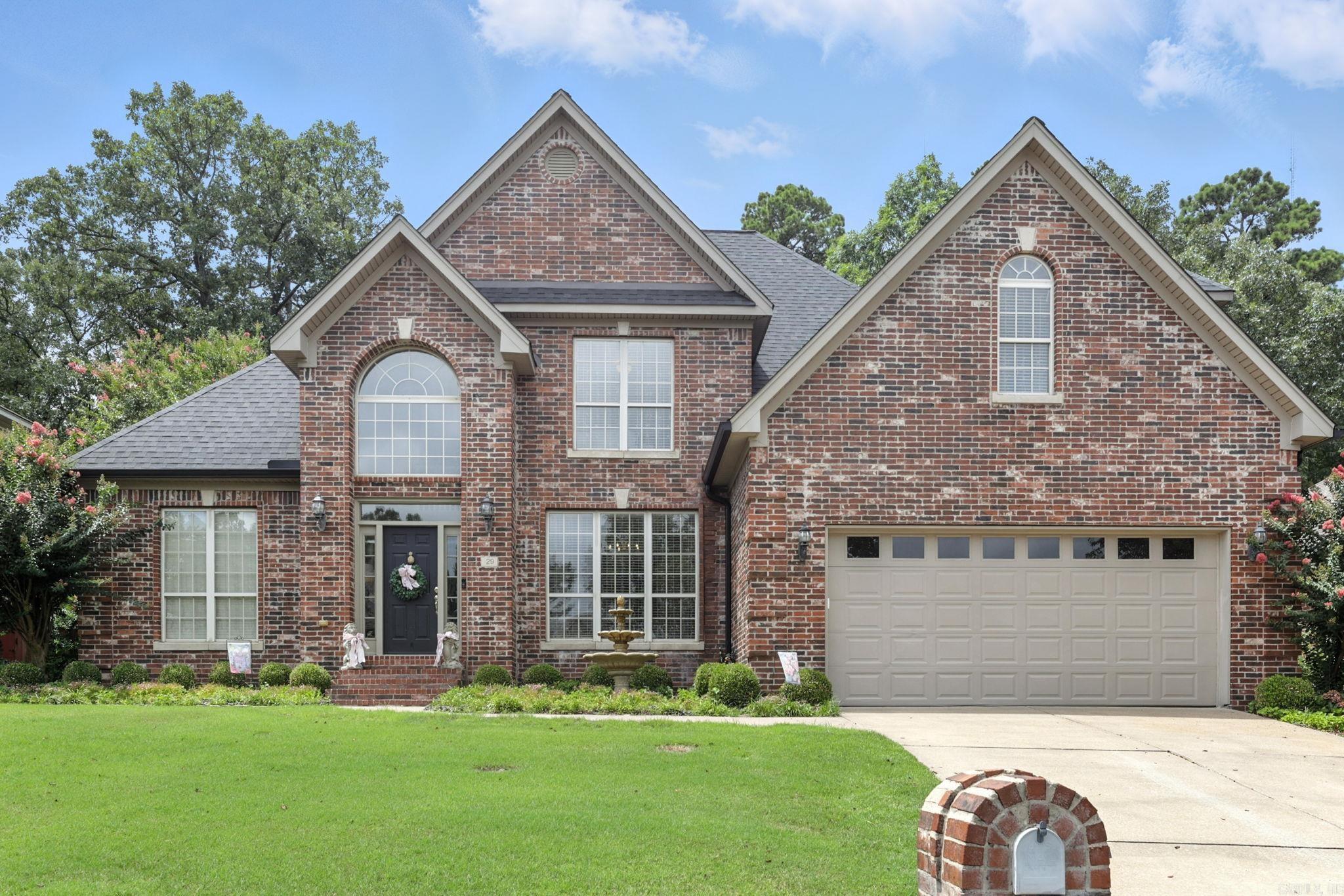 Traditional brick home with new flooring throughout both levels and room for everyone to spread out. A welcoming foyer leads to formal living/office and dining rooms, while the heart of the home is a warm, inviting kitchen with cooktop island, wall oven, large pantry, breakfast bar, and informal dining area. Just off the kitchen is a bar area and powder bath, with the spacious great room featuring a fireplace and access to the beautiful backyard. Outdoor living includes both covered and uncovered patios, landscaped garden areas with abundant trees and flowers, ideal for relaxing or entertaining. The main level primary suite has an updated bath, two closets, and a generous sitting area. A large guest suite with updated bath is also on the main floor. Upstairs offers three roomy bedrooms, two share a bath, and an additional hall bath, plus a large bonus room perfect for TV, playroom, or hobbies. Two car garage includes plenty of storage. Come see.