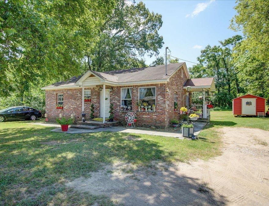 Brick Bungalow on Double Lot | Buildable Bonus Parcel | Central Location  Updated 3-bedroom, 2-bath brick home situated on a double lot in a convenient central location. This well-maintained bungalow features hardwood floors, new stainless steel kitchen appliances including refrigerator, stove, and dishwasher, and a stackable washer and dryer that convey.  The home offers covered front and back porches and a neatly kept yard, providing comfortable indoor and outdoor living space. A newly added storage building adds functionality for tools, equipment, or additional storage needs.  The additional lot at 303 Dexter is cleared and may offer potential for future construction, subject to city approval and zoning requirements. This bonus parcel provides flexibility for expansion, additional development, or long-term investment.  Move-in ready brick home with recent updates, extra land, and options for future use—all in a centrally located setting.