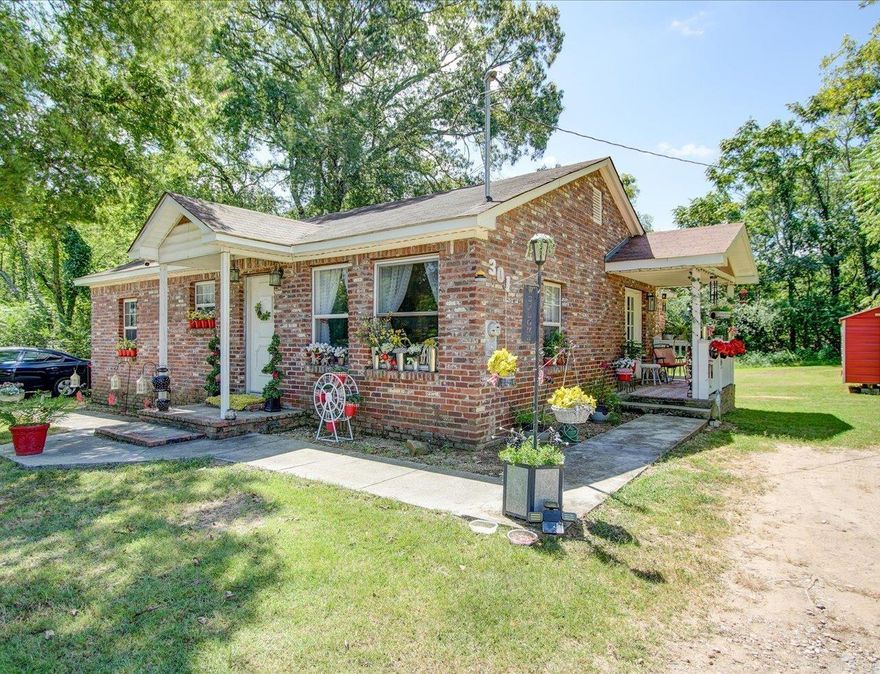 Brick Home with New Stainless Appliances on Double Lot + Buildable Bonus Parcel  Updated 3 bed, 2 bath brick home on a double lot, featuring hardwood floors, new stainless steel appliances (refrigerator, stove, dishwasher), and a new storage building. Stackable washer/dryer conveys. Covered front and back porches and a well-kept yard add extra value.  Second lot at 303 Dexter is cleared and ready for potential new construction with city approval.  Move-in ready with solid updates and flexibility for future use or investment.  AGENTS see showing remarks/schedule with Showingtime
