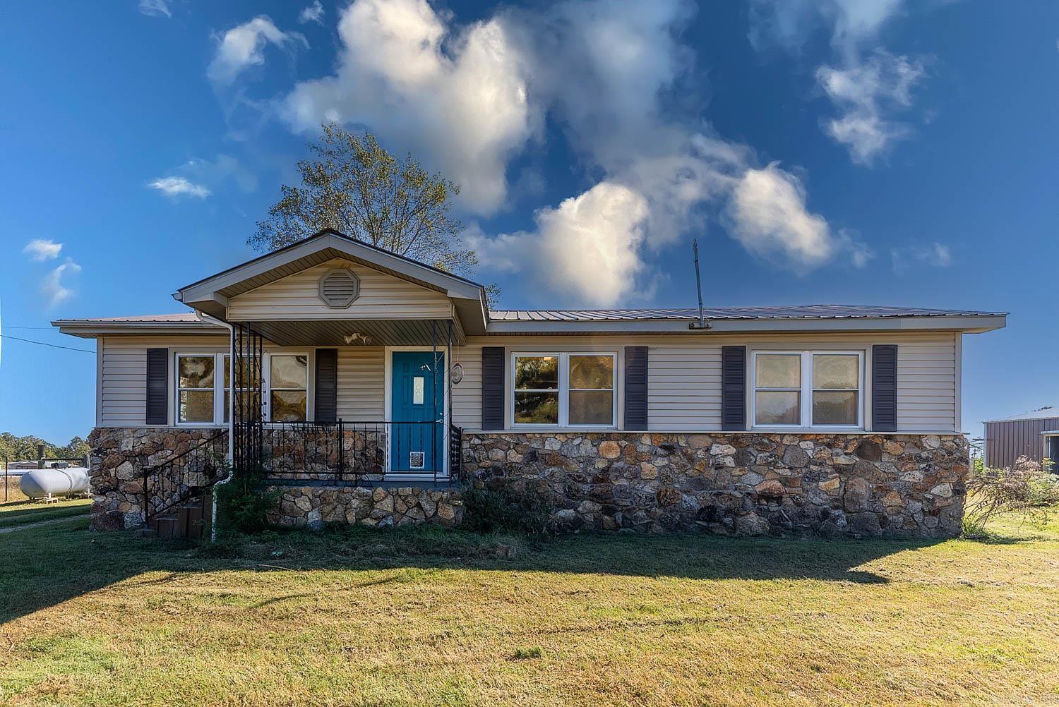 This well-kept 2-bedroom, 1-bath home on 4+/- acres m/l offers country living with plenty of room to grow! The oversized bathroom and large rooms make this home feel spacious and comfortable, with the potential to easily convert into a 3 or even 4-bedroom layout. The living room features a cozy fireplace with a propane insert, perfect for relaxing evenings at home, while the large pantry provides ample storage for all your kitchen essentials. Outside, the 4+/- acre property is fully fenced and divided into two distinct paddocks, making it ideal for livestock or horses. Two concrete-floored shops with electricity provide endless opportunities for hobbies or business, and one shop is equipped with a game cleaning station and meat hanging locker, making it a hunter's dream. This charming property offers the perfect combination of comfortable indoor living and outdoor utility, ready for whatever rural lifestyle you envision. Broker/Owner