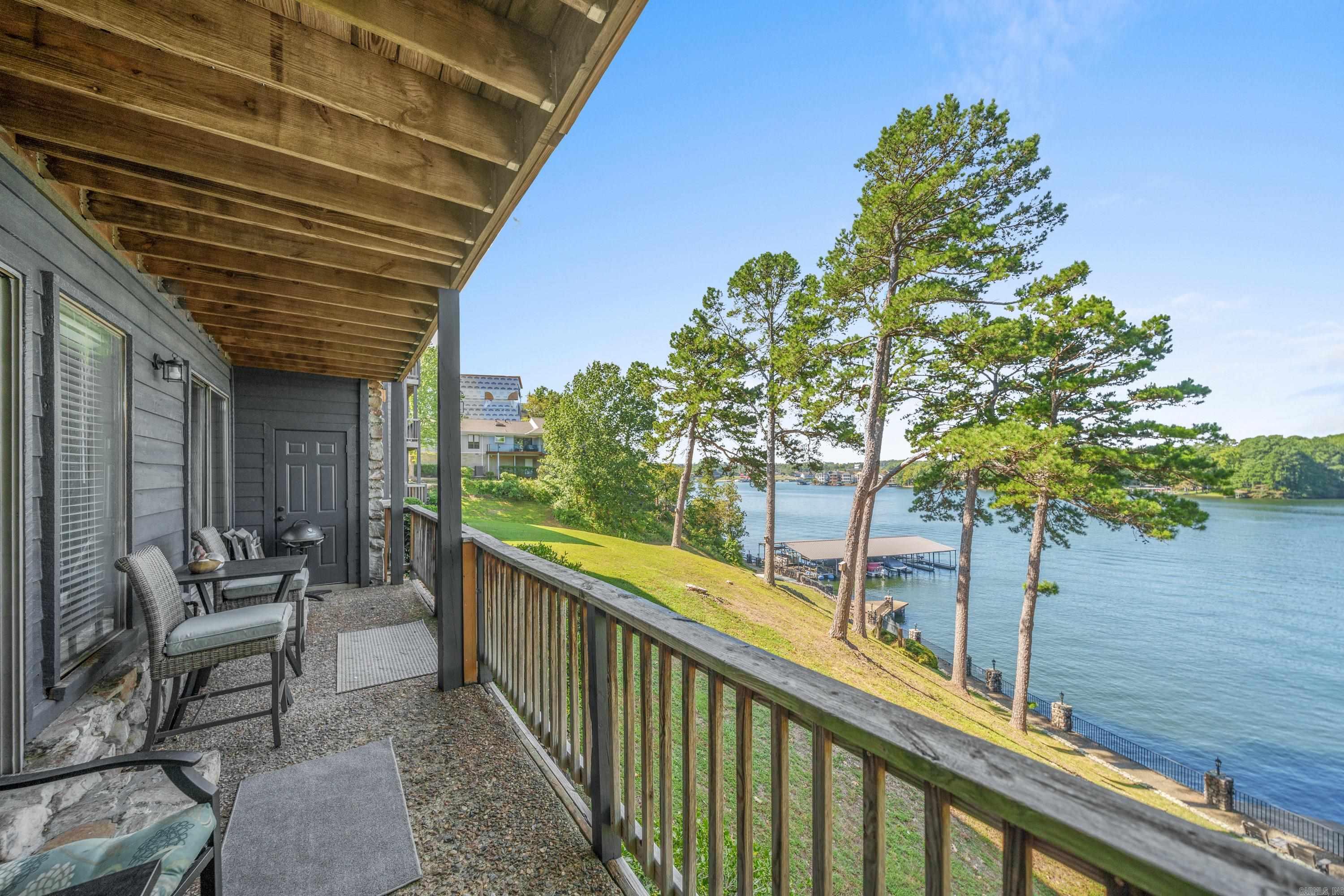 Experience the epitome of lakeside living at this fully furnished turnkey condo, conveniently located off Airport Rd. in Hot Springs, AR. This property offers a covered boat slip with a lift and is currently an income producing nightly rental, making it an excellent investment opportunity. Tailored for those seeking a luxurious getaway, the condo showcases beautifully decorated interiors, including walk-in shower, jetted whirlpool bath and a modern kitchen outfitted with stainless steel appliances & solid surface countertops, including a breakfast bar and wet bar with its own wine fridge. Located on the ground floor, this unit features two decks that offer spacious, breathtaking views of the main channel. This rare find also includes much sought-after covered parking and an additional parking space conveniently located by the front door. Donāt miss the chance to live the lake life in style at this exceptional Lake Hamilton condo, complete with gated entry, community tennis courts and pool; life in Hamilton Harbor will feel like a vacation every day.