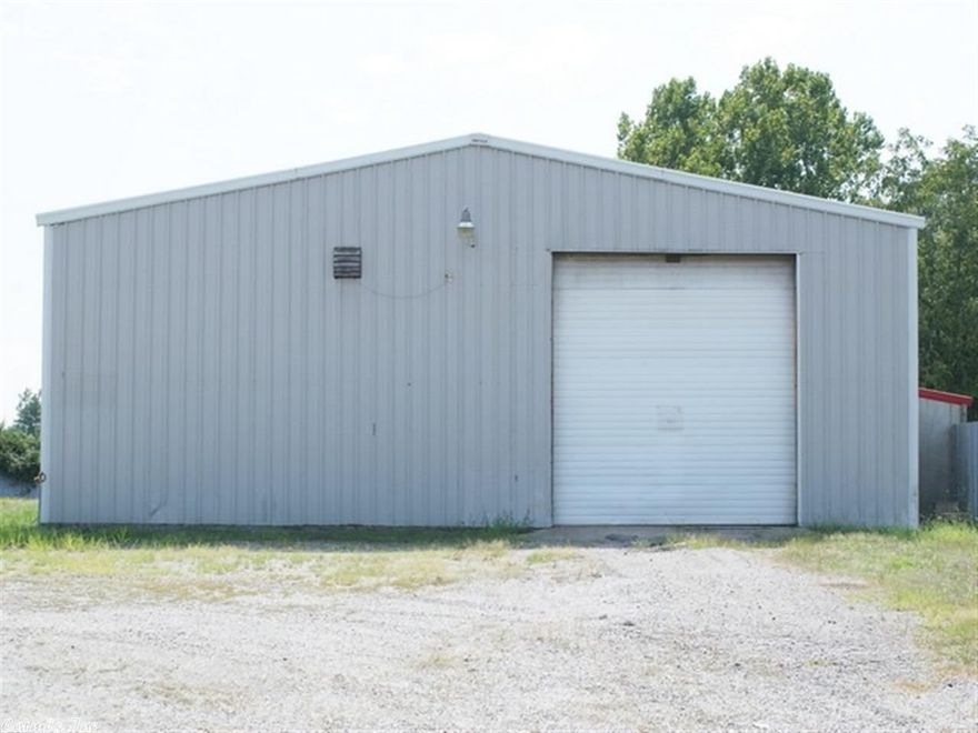 Nice 3750 sq. ft. building in a high traffic area. Ideal property for garage, car lot, and shop building.  Shop and Office space with 1.58AC compacted graveled yard. Building contains 1 office, rest room with shower, and direct access to the shop area. Concrete floor in the shop with a 3X36 pit to go underneath vehicle to work, 7hp 60 gal two stage working air compressor, and 3 large 14' ft overhead doors with drive thru. Great buy, owner taking a loss.