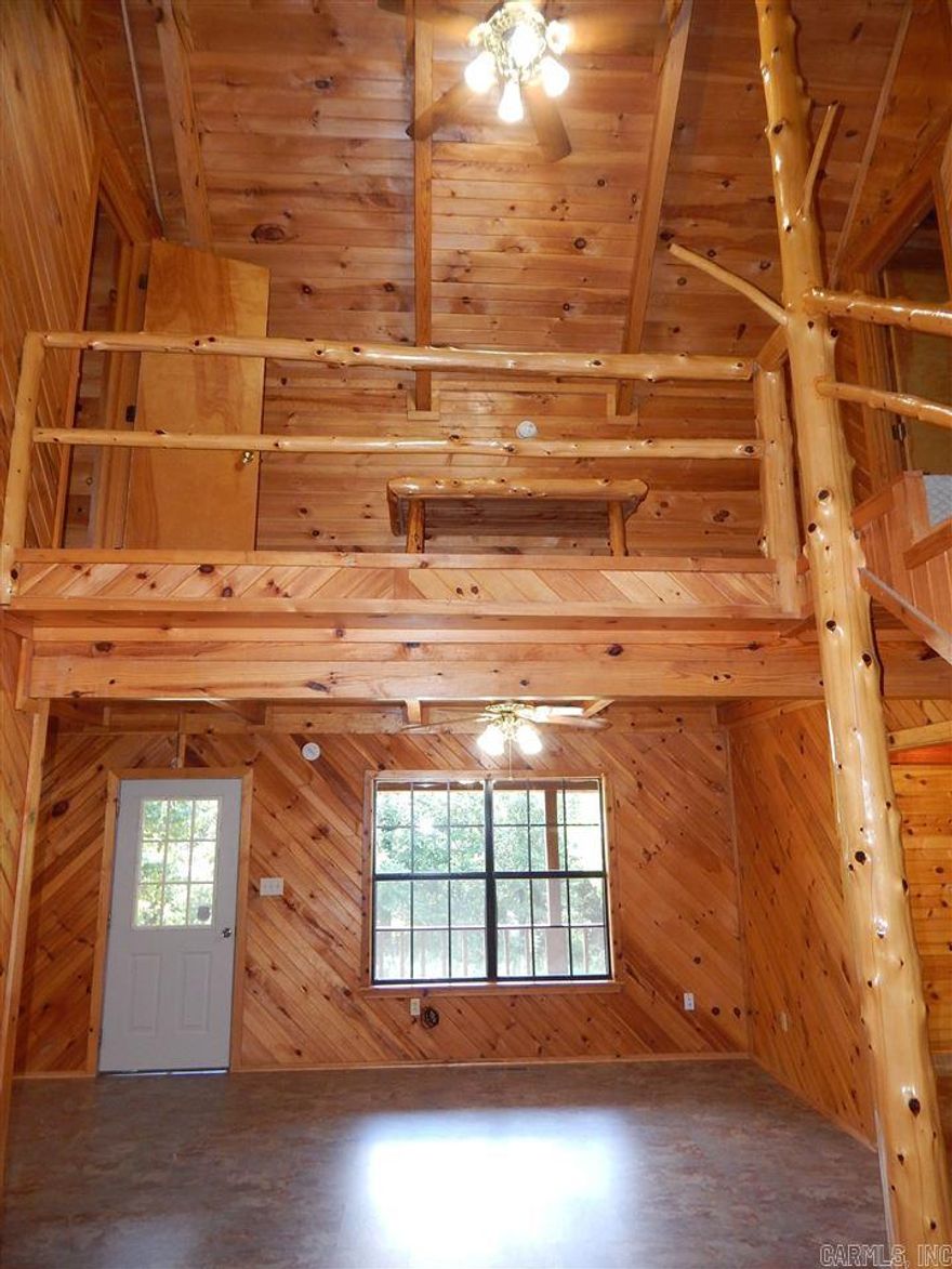 I am basically giving this house away! Someone is going to get a great deal. Don't let somebody else beat you to it. UPDATED LOG CABIN STYLE HOME! New heat & air, exterior stain, SS appliances, HWH, cork flooring downstairs, carpet on stairs & mstr bed, tile in upstairs bath, some lighting, and other (electrical, framing, plumbing). Extensive (& EXPENSIVE) interior WOODWORK. Nice view. Storage bldg. Metal roof. Nearly wrap around porch & balcony. Should qualify for $0 down RD loan. Agents see remarks.