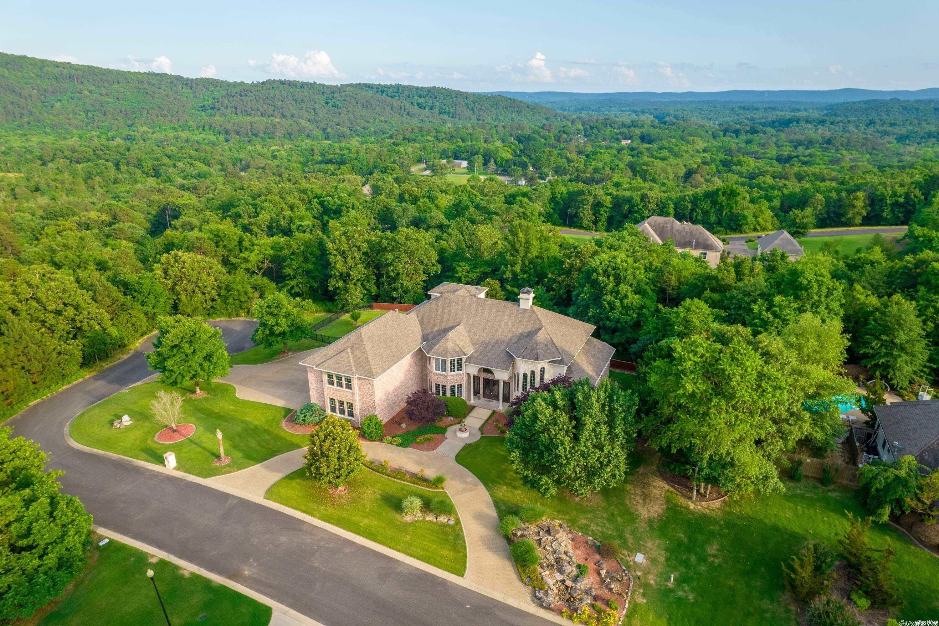 This gorgeous custom home had no expense spared when being built! Over 6,000 sq. ft. of luxury sitting on one acre at the end of a private cul-de-sac in one of Hot Springs most desired gated communities, Quail Ridge. This is a perfect home for a large family, there is room for everyone! Huge media/workout room. Home office with fireplace joining the grand room. Master suite located on the bottom floor. Craft room/bedroom. Third floor loft/man cave with stunning views! 4 car garage with tons of storage.