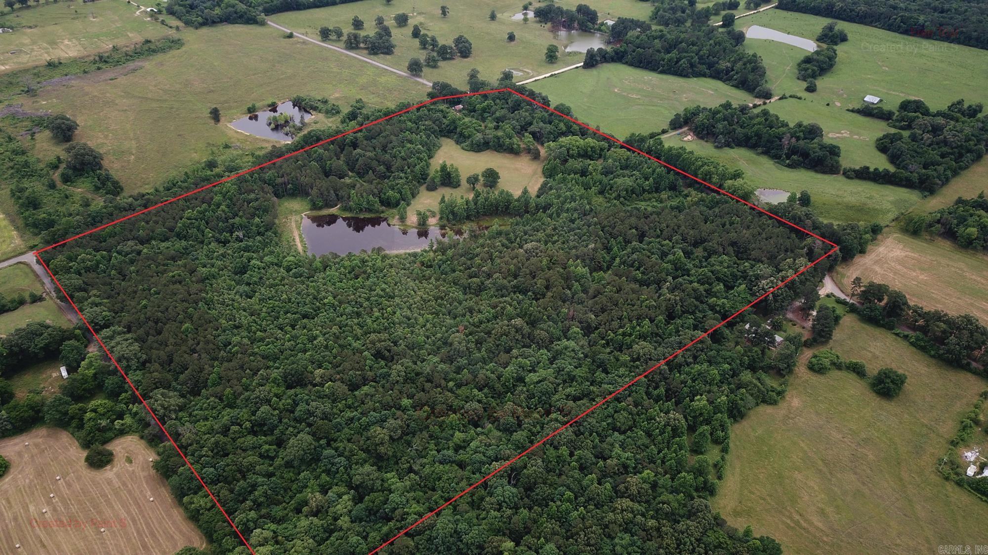 This 47 +/- Acres in Polk Co near Cove, Ar offers beautiful landscapes for someone looking for the right place to build their forever home. As you drive into one of the four gated entrances you will be met with an area of just over 4 acres of pasture that is surrounded by mature, towering hardwood trees looking down over the pond. There is a large barn that sits on the edge where you can store tractors, implements or any other equipment. The property has been well maintained with atv trails allowing access to every corner. As you take the trails across the pond to the northern side of the property, you will find younger hardwoods with mixed pines passing by deer at almost every turn. One of the nicest features of this property is having paved road access on three sides, so no need to worry about dust from the few vehicles that pass by this queit, secluded property. With power and a well already in place there are endless oppurtunitues here. Not to mention you are only 15 minutes to the nearest Ouachita National Forest Access and 25 miniutes from the Cossatot River State Park Natural Area.