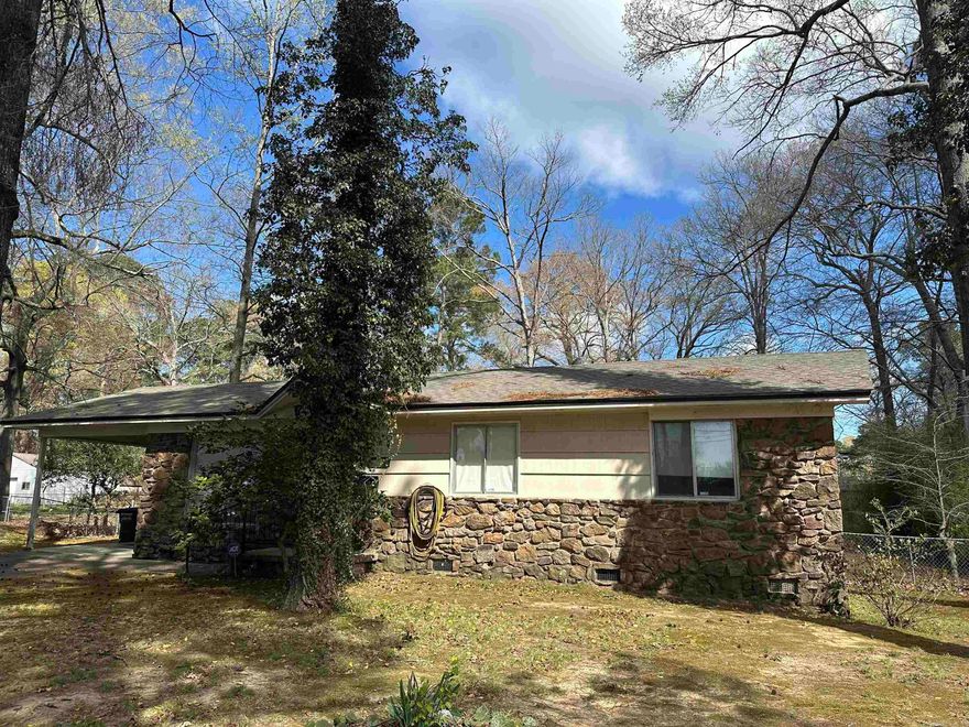 This property has a lot to offer! It sits on almost 1/2 acre. There is a large building in the back that is heated and cooled with a covered patio area and  also has its own bathroom with shower, sink, and toilet.  There is also a small storage building in the backyard. The main house has original hardwoods under the carpet. A new roof put on in 2022 on the main home as well as the building in back. Home has a front living space and open kitchen/dining. It also has a den area on the back side of the home. A little TLC and you would have a great property! Schedule your showing today! Call CSS 244-0333