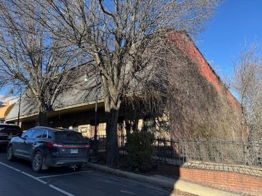 8000+ SQ FT OF OFFICE SPACE & HUGE PARKING LOT!  8115 square foot with approximately 15 offices, 1 full bath and 2 half baths. 3 entrances so it could be 3 different businesses but interior doors to each office area if needed for one big business. 2 central heat and air units in working order. Large basement storage area. Building does need some maintenance. Nice private parking lot joins building on the side. High visibility from US Highway 67N. Located on Everett Street just off Historic Pocahontas Court Square. Only $23 per square foot!