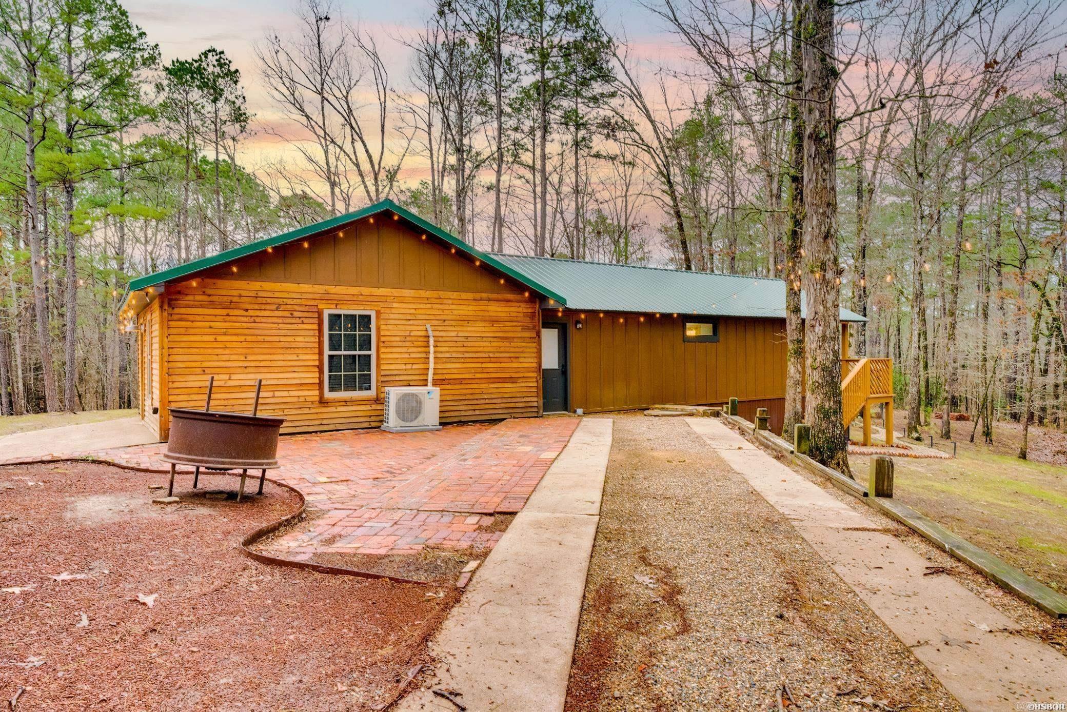 Discover your dream retreat with this renovated and fully furnished 3-bedroom, 2-bath home bordering the Corp of Engineers on Lake DeGray. This propertyoffers a unique blend of modern comforts and outdoor adventure, making it the perfect getaway for families and water enthusiasts alike. Nestled on aspacious lot ideal for a variety of lake activities, the property features ample outdoor space with a fire pit and covered hot tub. The surrounding landscapeprovides a serene backdrop, perfect for relaxation or entertaining guests. Step inside to discover an updated interior that exudes warmth and style. With itsmodern updates and expansive outdoor space, it’s the