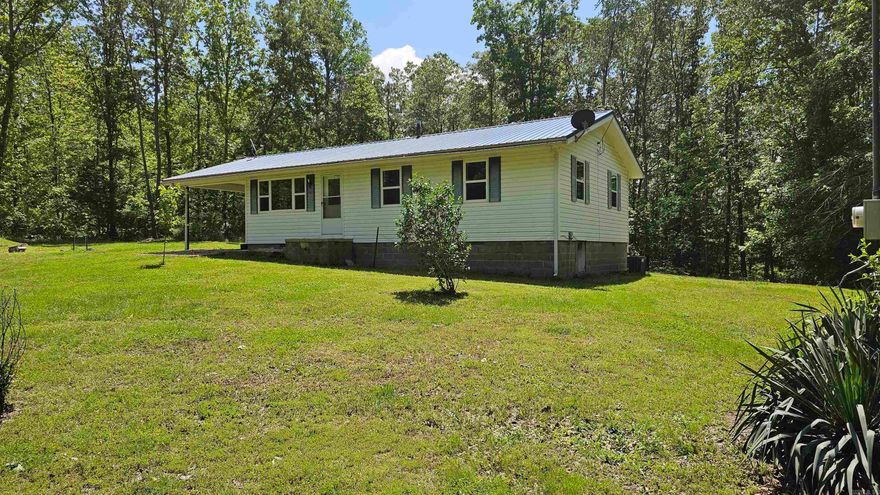 Welcome to this charming 3-bedroom, 1-bath home situated just outside of town, offering both convenience and tranquility. This meticulously updated property features a new roof (2018), new drywall (2023), and a host of recent upgrades including new floors, doors, knobs, hinges, ceiling fans, lights, paint, and electrical outlets (2024).  Additionally, the home boasts a storm cellar for safety and peace of mind. While currently on city water, the property also includes a well.  Enjoy the serene surroundings, just 4.5 miles from where Bear Creek meets the Buffalo River, offering endless opportunities for outdoor adventures. Don't miss your chance to own this move-in-ready gem!