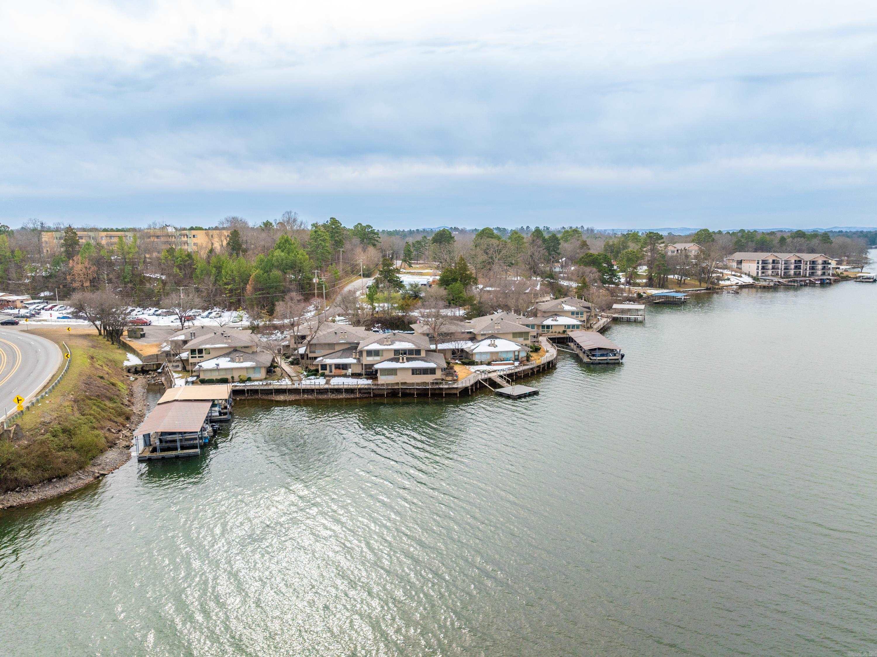 MUST SELL = NO REASONABLE OFFER REFUSED! PIER WEST CONDOMINIUM - 100 BAYOU PT....LAKE HAMILTON WATERFRONT CONDOMINIUM Updated Ground Level Unit- NO Steps -Park at your door! Weekend Boat Docking at your door! Contemporary design w/ (2) Fireplaces. Lots of Glass. Open Floorplan. Quartz counter tops. (2) Sundecks w/Great Views. Wood Acacia Floors. Cedar lined closet. Just steps away from the pool. Swim dock. Boat tie-up for daily use. Perimeter Camera. No nightly rentals - (3) month minimum allowed. UPDATES: H&A; Microwave; Range; HWH; Windows; Pool; Roof. Pet friendly community. MOVE IN READY.