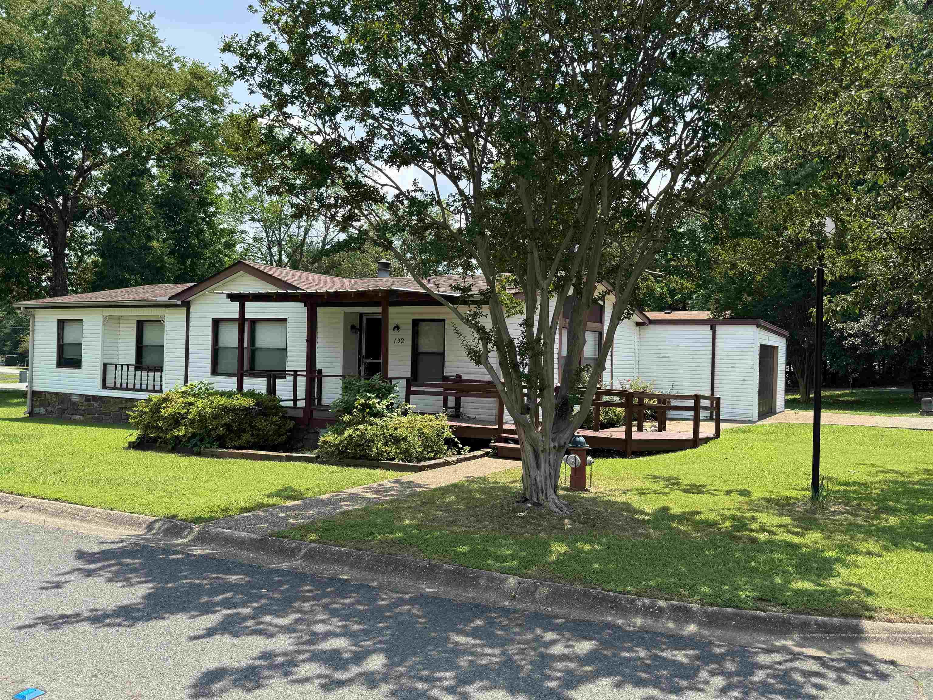 Welcome to this beautifully maintained and move-in ready home in Southwood Estates, a quiet and friendly 55+ community. Offering three bedrooms and two bathrooms, this home also features a versatile bonus room that can serve as a fourth bedroom, home office, or den-ideal for guests or hobbies. The spacious living room centers around a cozy fireplace, perfect for relaxing evenings. The kitchen and laundry area are well-equipped, with a washer and dryer that convey with the home. Recent updates include a new roof in 2023 and a newer HVAC system, ensuring comfort and efficiency year-round. One of the standout features of this home is its permanent foundation, which not only adds to the structural integrity but also makes the property eligible for long-term financing options-a rare and valuable benefit in manufactured housing. Outside, you'll find a screened-in back porch that's perfect for enjoying a morning coffee or evening breeze without the bugs. For pet lovers, there's an enclosed dog run that provides a safe and convenient space for your furry companion. The front porch and master bathroom have been thoughtfully designed to be handicap accessible.