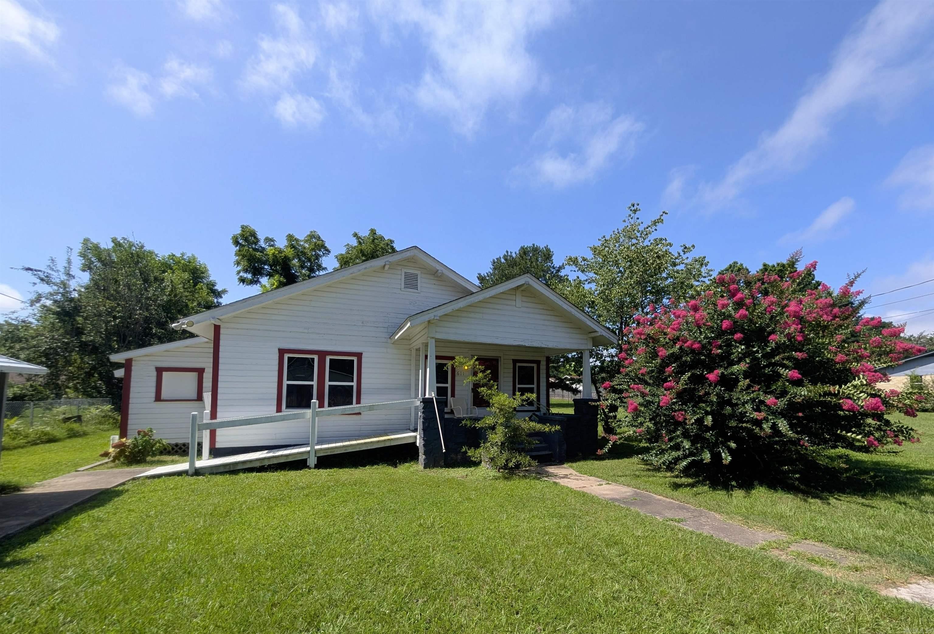 Move right in and make it home! Wheelchair accessible with tiled roll-in shower, newer kitchen cabinets, brand new flooring in the kitchen, primary bedroom and living room, newer appliances, energy efficient windows, walk in master closet! Extra insulation in the walls, extra wide doors for wheelchair access. Even has ramp to the front porch. Carport, nice outbuilding, garden area, landscaping and fencing on a huge lot!